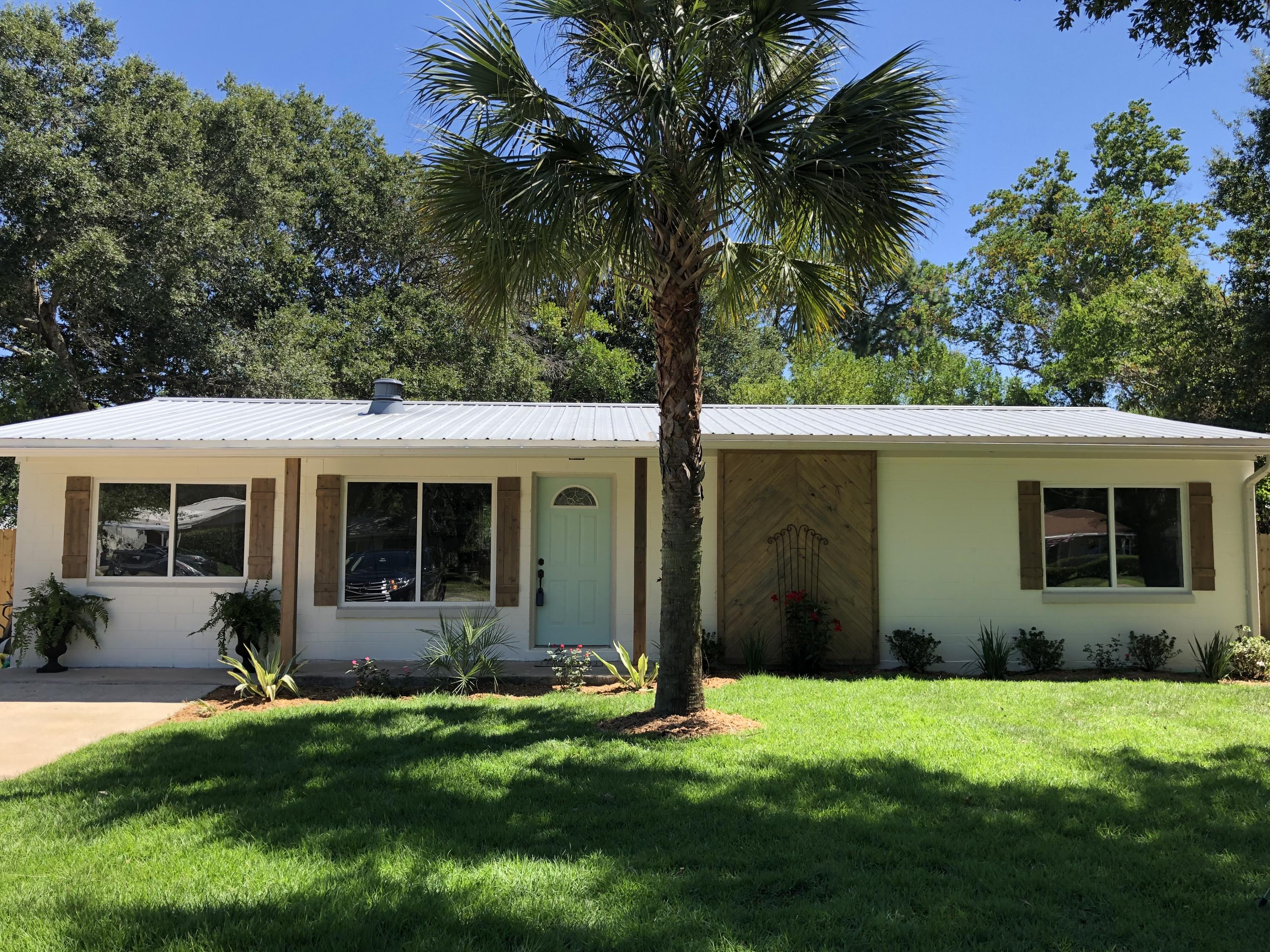 REMODELED TO PERFECTION!Adorable completely remodeled Florida Cottage located on a huge .25 acreage lot near great schools in the heart of Fort Walton Beach.This home features NEW EVERYTHING! Brand New AC. All new electrical and plumbing throughout. Brand new waterproof luxury vinyl throughout entire house, granite countertops, new cabinets in kitchen and both bathrooms, new stainless steel appliances, gorgeous walk in shower in master, bright and open sunroom, split bedroom plan. Home is a solid center block with metal roof, cedar shutters and columns, large backyard with utility shed, beautifully landscaped... plus so much more! This is a must see property!! Not anything on the market like it. Will not last long!