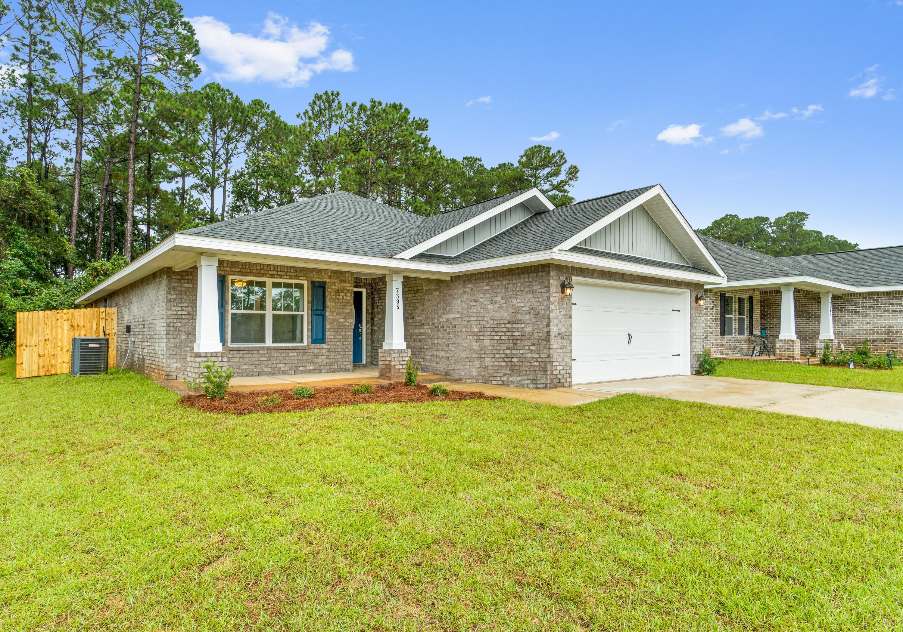 Welcome to the Carlos Floorplan. This exquisite 3 bedroom, 2 bath brick home offers modern living with a spacious, open, split floor plan, featuring large vaulted ceilings, crown molding, and 2'' faux wood blinds. The open layout seamlessly connects the kitchen to the living and dining areas, making it perfect for entertaining. The kitchen is a chef's dream with stainless steel appliances, granite or quartz countertops, bar seating, a full pantry, and solid wood soft-close cabinets and drawers, all elegantly detailed with brushed nickel hardware. The grand master suite features a luxurious master bathroom designed for relaxation, complete with a garden tub, a separate all-tiled shower with dual shower heads, double vanities, and two large walk-in closets. Enjoy your .25 acre lot in peace  with a full backyard privacy fence, providing ample space for outdoor activities and relaxation. Situated in a highly desirable new subdivision south of I-10, just off Hwy 87, this home offers easy access to both Navarre and Milton. Additionally, you'll be just 20 minutes away from the pristine white sands of Navarre Beach, making coastal living a breeze. Projected completion is April 2025. Photos are of a similar home; colors and selections may vary. Don't miss out on the opportunity to own this beautiful new home!  Home will be available by 4/4/2025. 