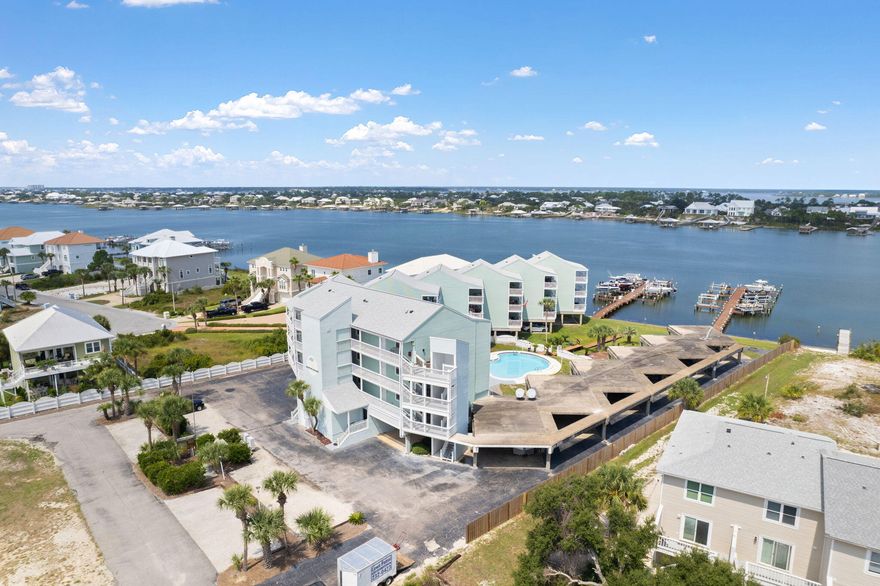 Looking for a short-term rental investment? Look no further- Docks on Old River #14A- Situated on Old River in Perdido Key, this unit offers peace and tranquility year-round as a lower-density condo complex. 14A is a stunning 2 bedrooms and 2 bathrooms recently upgraded and perfectly furnished for the coastal vibes. This unit is fully furnished minus a few personal items, which makes it MOVE-IN READY! Freshly laid flooring, contemporary cabinets, stainless steel appliances, a subway tile backsplash, and a new coat of paint enhance its charm. The property features upgraded air conditioning and a water heater installed in 2020. Step onto the expansive covered balcony to witness captivating views of the mesmerizing Old River and the pool below.