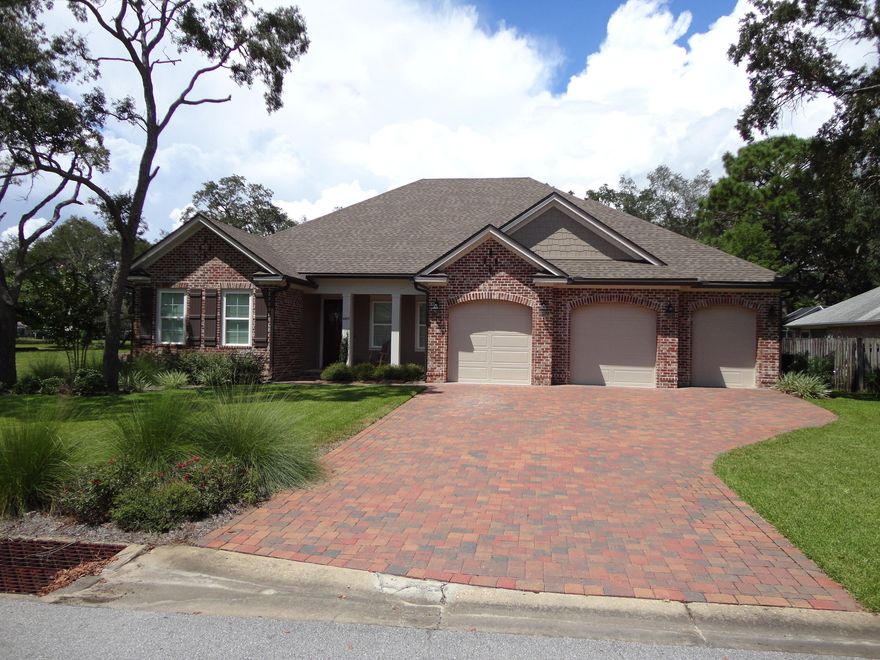 Jump on this exceedingly rare opportunity to own a 4-year old Randy Wise Homes' craftsman style property in the established, gated Southwind neighborhood of Bluewater Bay. From the brick-paver drive to the fully fenced backyard, everything is turnkey; simply move in and focus on the excellent quality of life you'll enjoy here! An open-concept kitchen, dining, living area lies at the heart of the home PLUS a flexible bonus space just behind glass-paneled French doors. The split-bedroom layout smartly positions two bedrooms sharing a common full bath and a third bedroom with en suite bath on one side of the house, while a grand master bedroom and spa-like bath can be found on the opposite side. Beautifully appointed with hardwood flooring throughout the living spaces, tile in wet areas,