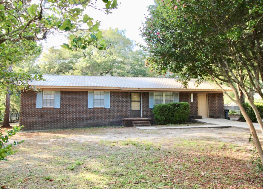 Brick home with metal roof on large half acre lot inside the city limits of DeFuniak Springs. Walk to schools and parks! Tile floors throughout and converted garage makes a wonderful office/playroom/future 4th bedroom. Kitchen is open to the dining area and living room. The interior was just painted and is ready to go!