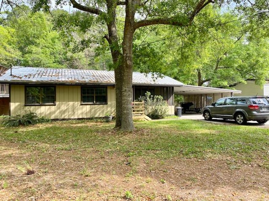 This cute 3 bedroom home is perfect for a family that wants to be close to the beaches, shopping, boat launch with park. Nice size lot with mature trees, double carport with lots of parking on concrete driveway. The two story shed is perfect to store a boat or for that handyperson needing space to create. Recent new metal roof and front steps. The home is move in ready but could use a little TLC. Great investment or family home for that lucky buyer! Home being sold ''as is''.