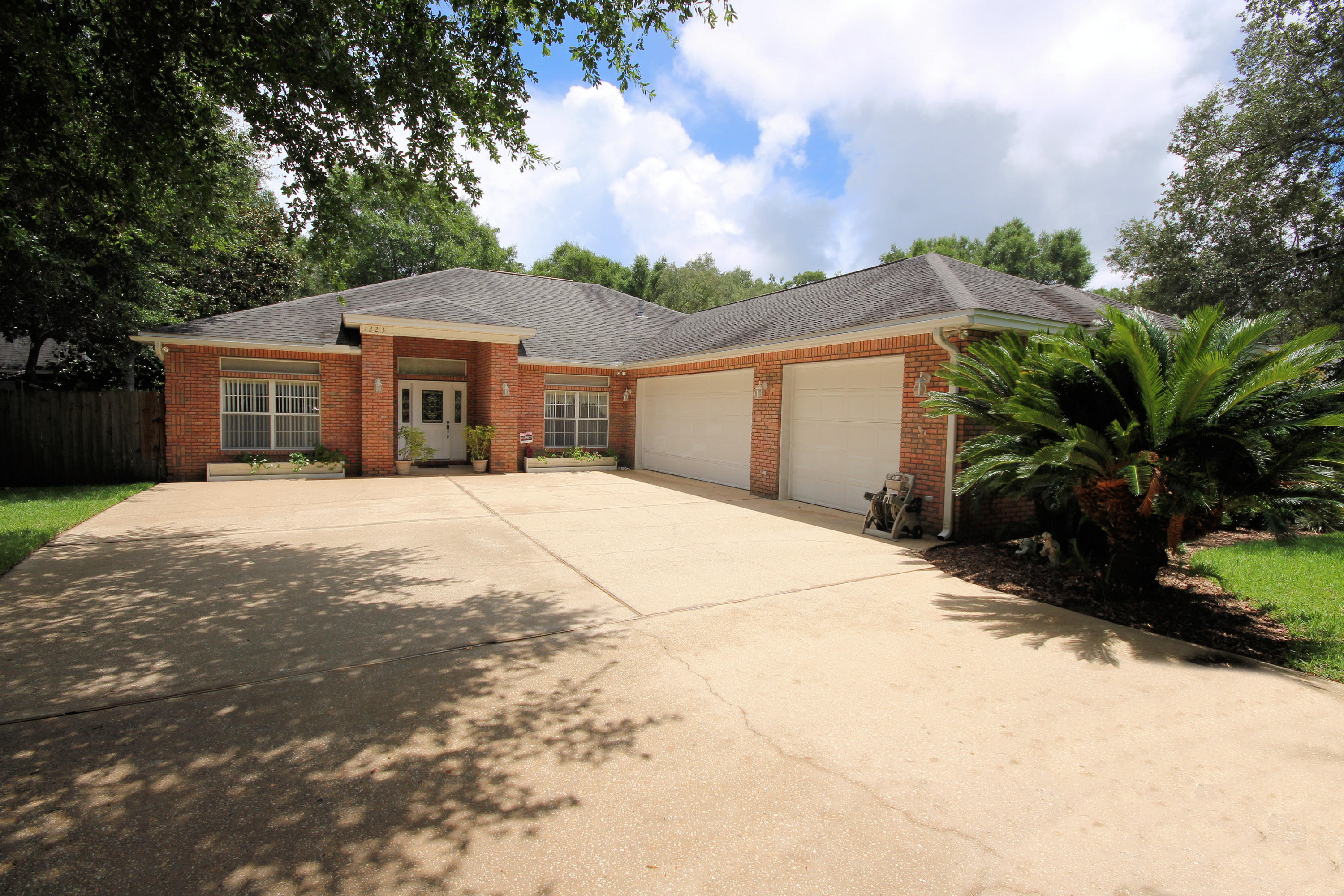 Gorgeous all brick home built in 1995 with 2823 sq. ft, 3 bedrooms, 2 bathrooms, and located in the desirable Kenwood neighborhood. This convenient location provides water access and is in close proximity to the beaches, shopping, restaurants, excellent schools, and the military bases! Enjoy paddle boarding, fishing, and watching dolphins from the community dock and boat ramp! Seller is replacing the roof with a 30-year dimensional shingle! Enter the lead glass front door with side panels and notice the 10 foot ceilings from the foyer! This home features an open floor plan with the kitchen opening to the living room and eat-in kitchen area and dining room. The living room is spacious and features a gas fireplace, crown molding, and recessed lighting.