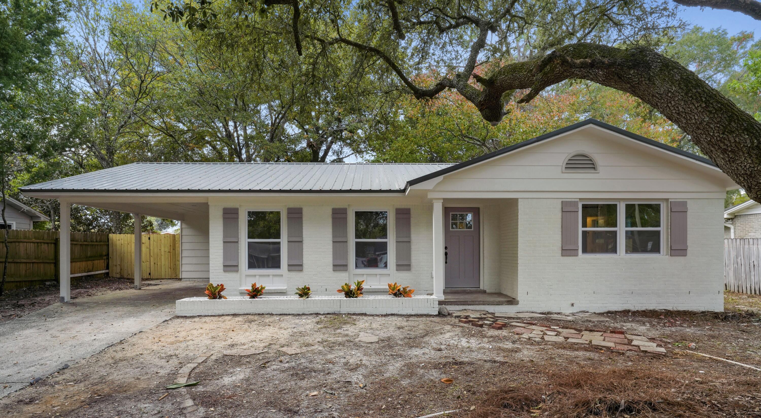 **NEW METAL ROOF, NEW HVAC AND DUCTING, NEW WATER HEATER, NEW WINDOWS, AND NEW ELECTRICAL WIRING!!** Welcome in to this beautifully renovated 3 BR/1.5 BA home boasting beautiful, modern coastal finishes throughout. This home has been upgraded from top to bottom with floor to ceiling paint, updated kitchen and baths, LVP flooring, recessed lighting, 6-panel doors, all new trim and 1x4 baseboard, custom closet shelving, and modern matte black door hardware throughout. Walking into the home, you will be greeted by an open living, dining, and kitchen with tons of natural lighting and contemporary charm. The custom accent wall in the living room provides a modern flair and sophistication. Moving thru the home, the details don't stop there!