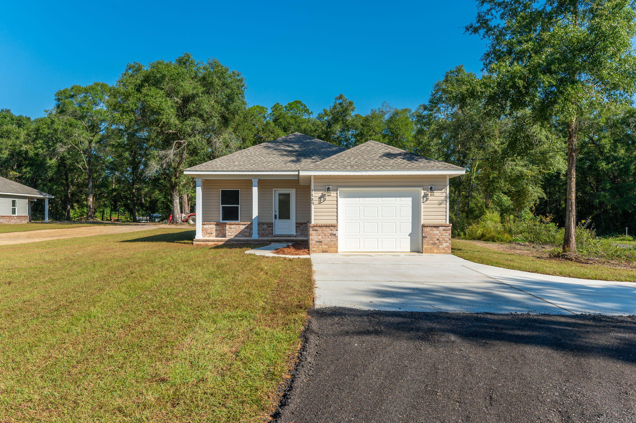 Step inside this new 2024 home built by Jim Robertson Home, showcasing 1496 sq ft of living space, 3 bedrooms, and 2 baths on a sprawling almost 3/4 acre lot. The neutral color palette and LVP flooring complement any decor style, while the  kitchen features quartz countertops, stainless steel appliances, and a breakfast bar with shiplap accents. Both bathrooms boast marble vanity tops and marble tub backing in hall bath, and the master bath also includes a full marble walk-in shower. Relish the morning sun or evening serenity on your back porch. Take advantage of the $10,000 anywhere money offered by the builder to customize your dream home.