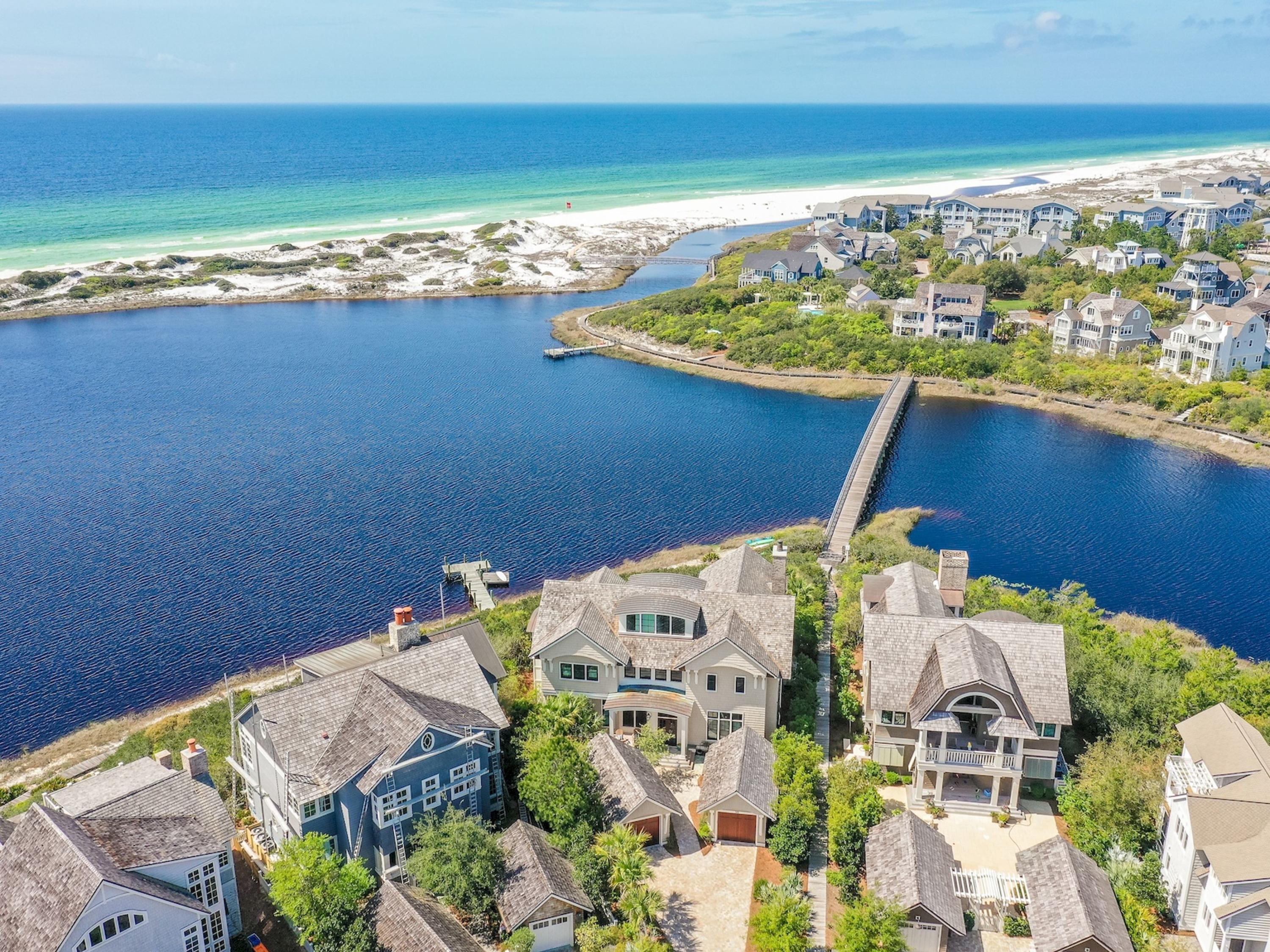 Panoramic Gulf and Lake views abound from this waterfront ''corner'' of Watersound's preferred Peninsula location. This luxurious residence of grand & gracious spaces plays host to captivating views of undisturbed sand dunes and the emerald waters of the Gulf of Mexico! And all to be enjoyed from the privacy of the heated spa/pool and outdoor living room with fireplace adjacent to a well equipped Summer Kitchen. The phenomenal location is a prelude to the masterful design and quality construction of this 3 story abode offering 5 bedrooms/6 Baths. Level 1 hosts 4 guest bedrooms with en suite baths with access to the resort style Courtyard. Level 2 boasts open living spaces with a large chef and prep kitchen, indoor/ outdoor dining areas, expansive living room and master bedroom retreat.