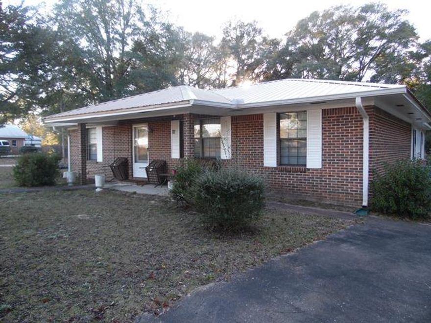 This is a beautiful brick three bedroom house with a large fenced in yard that includes two storage buildings. The home also has a large bonus room for entertaining. There are two storage buildings (one block and one metal). All hard surface flooring. Bruce hardwood in large addition to home. Wood Laminate in living room and bedrooms, Tile in kitchen, baths and laundry room. Newer modern metal roof. All appliances included (refrigerator, stove, microwave, washer and dryer). Some of the remaining furniture is negotiable. This home is a must see!!!