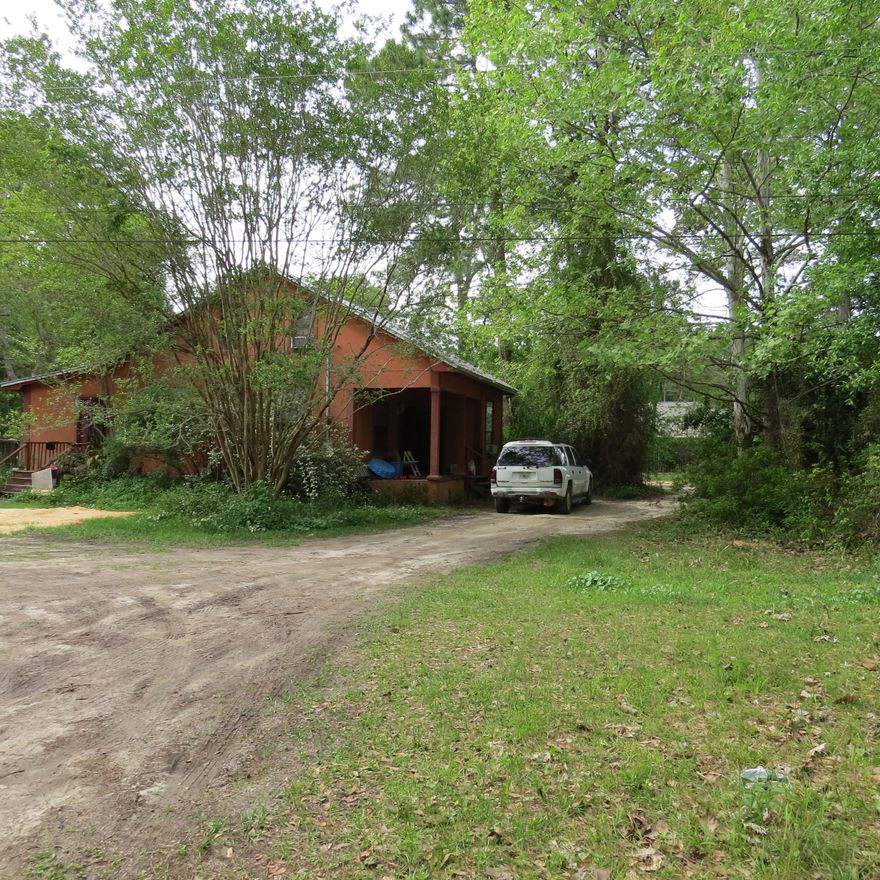 Country home on paved road conveniently located close to shopping, beaches and Sacred Heart hospital. Home needs work. Priced to reflect this. Homes around are selling for more. Located on the corner of Grantham Ln and Mussett Bayou Rd. Located on 1/2 acre with circular drive in front of home.