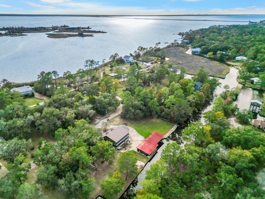 PRICED TO SELL!Old Florida waterfront living at 602 Pitts Bayshore Drive, Freeport. Situated on an oversized double lot (.79 acres), this 4-bedroom, 3-bath home with 2,475 sq. ft. of space invites you to embrace both family comfort and the luxury of life on the water.From the moment you arrive, the canopy of majestic live oaks welcomes you into a property that feels timeless, private, and full of possibility. The setting is truly unmatched 195 feet of protected canal frontage provides quick and easy access to Choctawhatchee Bay and the surrounding rivers, making every day feel like a boating adventure waiting to happen. This home is designed for the waterfront lifestyle with two fully covered boat slips with lifts, private boat launch for effortless days on the water and a fully powered boathouse workshop with dual entry doors for storing gear and equipment. Fall in love with the expansive yard space for gatherings, outdoor entertaining, or simply enjoying the natural beauty.

Step inside and large windows bring the outside infilling the home with light while framing serene water views. With spacious living areas, multiple bedrooms for family or guests, and a location that balances quiet neighborhood living with easy access to Highway 98, this home is ideal as a primary residence, vacation retreat, or investment property.

What sets 602 Pitts Bayshore apart is the lifestyle it offers mornings spent fishing off your dock, afternoons on the boat exploring Choctawhatchee Bay, and evenings under the oaks enjoying the peaceful coastal breeze. Here, every detail echoes the charm of Old Freeport while providing modern updates like a new AC system (2025).

This is more than a homeit's a place where families can grow, memories can be made, and the luxury of waterfront living can be yours every day.
