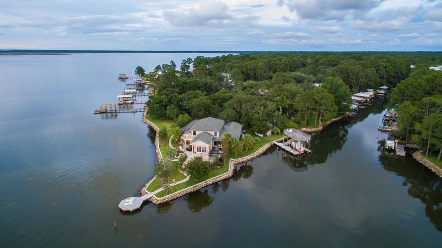 THE SUNSETS over the Choctawhatchee BAY from your own private slice of PARADISE are FABULOUS! 'PARADISE POINTE', a LUXURY HOME w/ 6br/4.5ba in 4692 sf, encompasses its own PRIVATE PENINSULA w/ an EXPANSIVE 500' of BAY FRONT PROPERTY. This OPULENT home boasts UNPARALLELED VIEWS & LUXURIOUS AMENITIES w/ the FINEST materials & finishes throughout. In the kitchen you find TAJ MAHAL MARBLE counter tops, WOLF 4 burner GAS STOVE, SUB ZERO refrigerator, freezer, and dishwasher, COPPER FARM SINK, and the gorgeous light wood cabinets made from RECLAIMED WOOD FROM CAMP WALTON. The generous BAY FRONT Master Bed/Bath has STEAM SHOWER and MAXX SOAKER TUB, His and Hers WALK IN CLOSETS, and 2 entrances leading to the patio area with private HOT TUB. There are VIEWS FROM MOST ROOMS. The DINING, LIVING, &