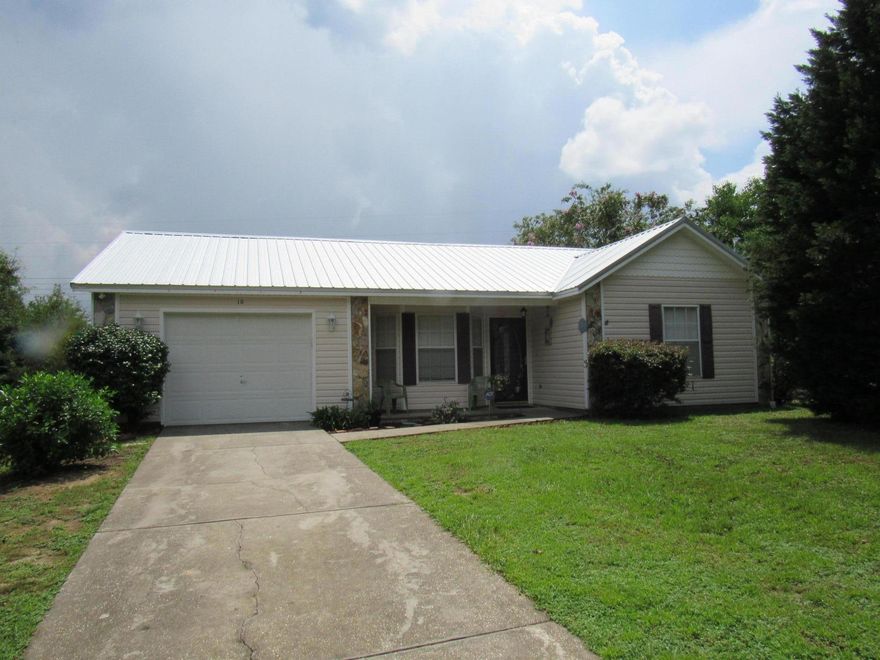 Move in ready! This traditional style home is located in the Aplin Heights subdivision. It has 3 spacious bedrooms in a split floor plan along with 2 bathrooms. Living room is spacious with high ceiling, ceiling fan. Home has a a galley style kitchen which stainless appliances and flat surface stove. Kitchen cabinets have a light wood finish and counters were installed in December 2014. Home has wood laminate in living room and dining area and hall and was also installed in 2014. Metal roof was installed and new HVAC system in 2013. It has lovely screened back porch to have a view of nature. A yard building also conveys. Call today to view this home!