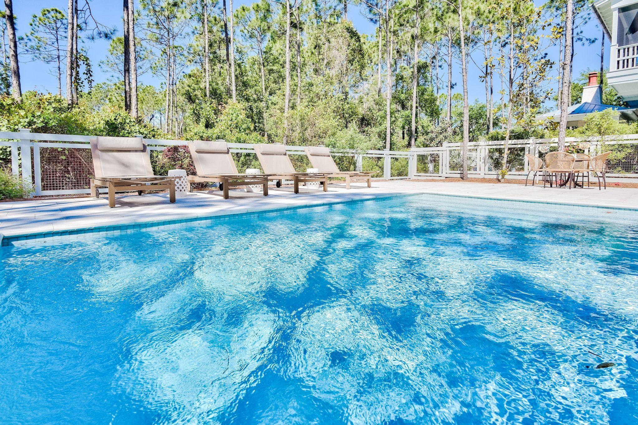 This spacious 4 bedroom home with large pool in WaterColor home has been meticulously maintained, never rented, resulting in an immaculate property. Enjoy a private backyard with a large swimming pool. with a nature preserve behind. Find luxury finishes throughout including refinished pine floors, lots of built ins, pecky cypress accent ceiling, 12' first floor ceilings, Quartz countertops, Sub-Zero and top of the line appliances and much more.Highlights of the spacious design plan include open living and dining spaces, a breathtaking master suite, all tile throughout home was provided by Q Tile and is top of the line. Master 2 additional bedrooms and hallway bunks with wraparound porch gives your family lots of room to spread out.
