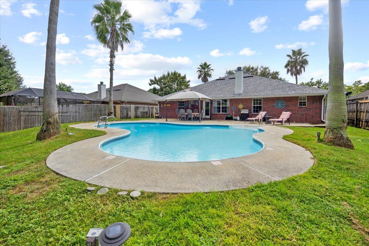 Welcome to 7006 Brighton Oaks Boulevard- a spacious 4-bedroom, 3-bath pool home offering 2,430 sq. ft. of comfortable living in the heart of Navarre. With thoughtful updates, modern conveniences, and plenty of room to relax or entertain, this property truly has it all. Thoughtfully designed for both comfort and functionality, this home features a formal dining room, living room, and flexible bedroom or office/study just off the foyer, perfect for today's lifestyle needs.The heart of the home is the open family room and gourmet kitchen, complete with a large center island, modern appliances, a walk-in pantry, and an adjoining dining area ideal for gatherings. The split floor plan provides privacy, with a tranquil master suite showcasing large windows, a spa-like ensuite, dual vanities, separate showers, two walk-in closets, and private water closets.
On the opposite side, two additional bedrooms with ample closets share a centrally located bath and a nearby laundry room that includes a washer and dryer. A fourth bedroom with its own bath offers versatility for guests or extended family.
Step outside to your private backyard oasis featuring a sparkling inground pool, lush landscaping, and a powered yard shed. Enjoy peace of mind with recent updates, including a new roof, new A/C & heater, Generac whole-house generator, new front and back doors, new master bath windows, new gutters with guards, and a sprinkler system.
Lovingly maintained by its original owner, this home combines thoughtful design, modern upgrades, and outdoor living at its best. 7006 Brighton Oaks is waiting for you to call it home!