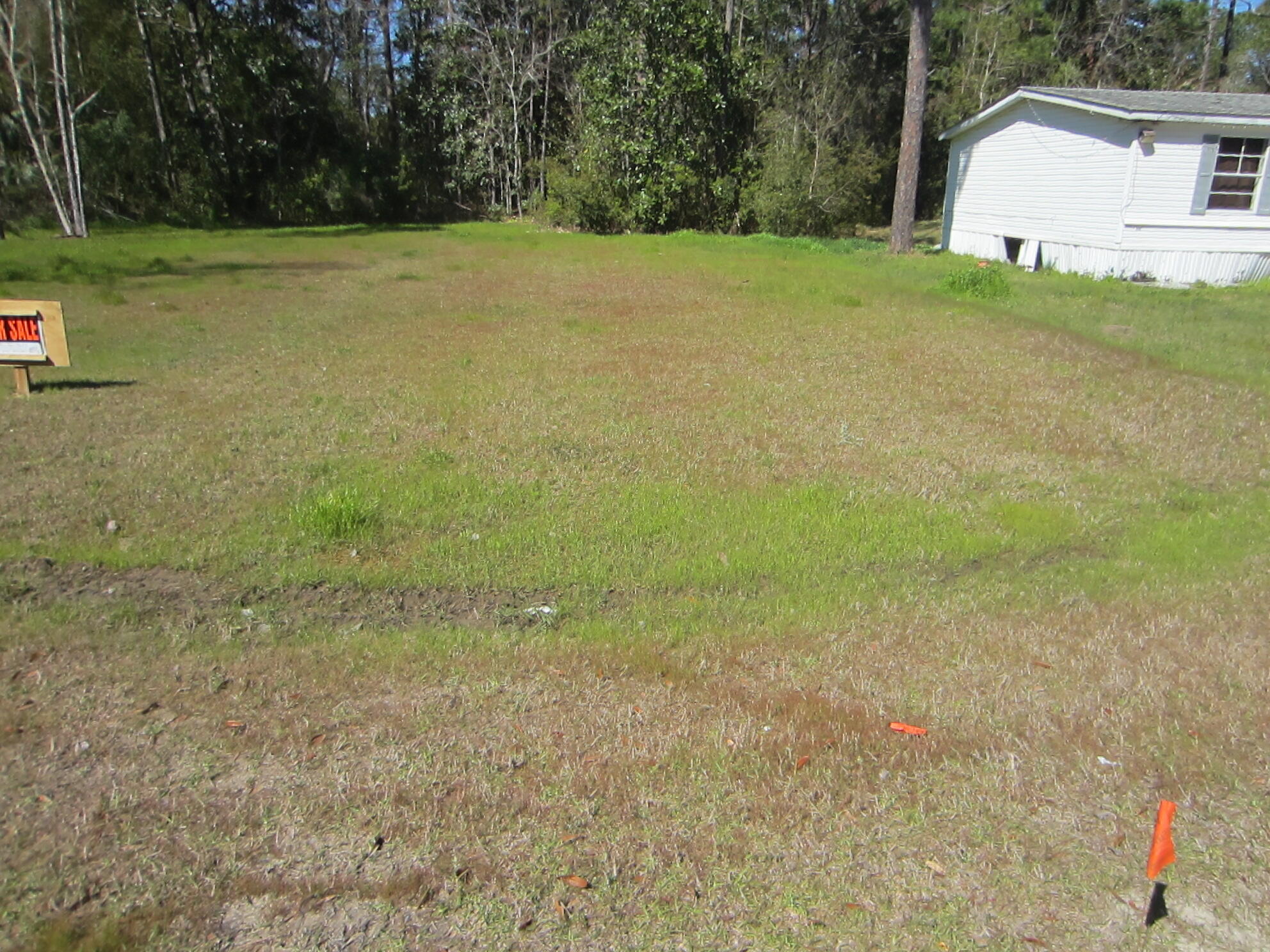 Cleared residential lot on the paved Indian Woman Road in beautiful South Walton.  There is 50 feet of road frontage and the lot has been cleared for easy construction of that new home. Just minutes from Cessna Landing where you can launch your boat.  Very fast developing area.  No HOA. Mobile homes okay. Public water and sewer available along Indian Woman Road and easily accessible.