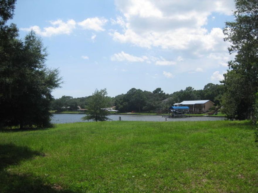 Beautiful waterfront lot with spectacular sunsets. Make memories as you build your dream home on this high and dry piece of land with sea wall already in place. The private drive sets the stage for your new home with mature Oaks flanked with Spanish Moss and panoramic views of Cinco Bayou.