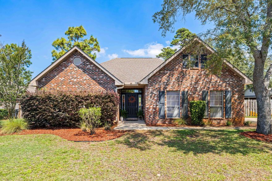 Situated on a spacious corner lot in the quiet, well-kept community of Peach Creek, this thoughtfully designed three-bedroom, two-bathroom home offers a relaxed, family-friendly atmosphere just minutes from the beaches and charm of 30A. With its open-concept layout, natural light and classic finishes, the home offers a practical yet comfortable setting for everyday living or a coastal getaway. Step inside to hardwood floors that run throughout the foyer, kitchen, dining and living areas. The kitchen features generous granite countertops, ample cabinetry and a layout that makes both cooking and gathering easy. Large windows in the main living space keep the home bright and airy, while the flow from kitchen to living area allows for seamless connection.The primary suite is set apart for privacy and comfort, with a spacious bedroom, a walk-in closet, dual vanities, a soaking tub and a separate walk-in shower. Two additional bedrooms offer flexibility for guests, a home office or growing families. Tile flooring in the bathrooms and carpeting in the bedrooms keep each space appropriately tailored. Outside, the fenced backyard and pavered patio provide a private place to relax, entertain, or play  framed by low-maintenance landscaping and supported by a full irrigation system. The two-car garage and extended driveway offer plenty of parking and storage space, while a built-in security system adds everyday peace of mind. Tucked into one of the area's quieter residential pockets and offering quick access to all the highlights of 30A, this Peach Creek home delivers comfort, simplicity and room to grow in a setting that feels both tucked away and well-connected.