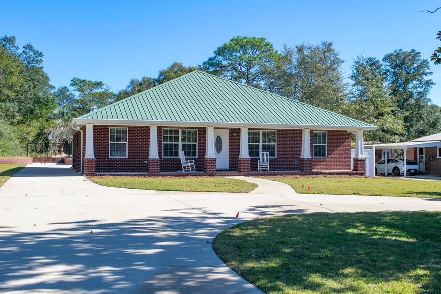 **PRICE IMPROVEMENT** Located between the desirable Poquito Bayou and Longwood neighborhoods, this 4-bedroom, 2-bathroom home offers an open floor plan with nearly 2,000 square feet of living space. Built in 2014, the property features volume ceilings, a metal roof, and a tankless water heater. The spacious primary suite includes a tray ceiling, walk-in closet, and direct access to the screened-in back porch. Additional highlights include LVP flooring, recessed lighting, ceiling fans, and a flexible room that could serve as an office or studio. The kitchen opens to a screened back porch through double French doors, perfect for indoor-outdoor living. Enjoy a private, fenced backyard with an updated in-ground pool featuring a brand-new liner, pump, filter, and surrounding deck. The 2-car carport includes an 8x12 enclosed storage space with a doggy door that leads to a fenced dog run. Circular driveway and large lot provide plenty of parking and room to spread out.