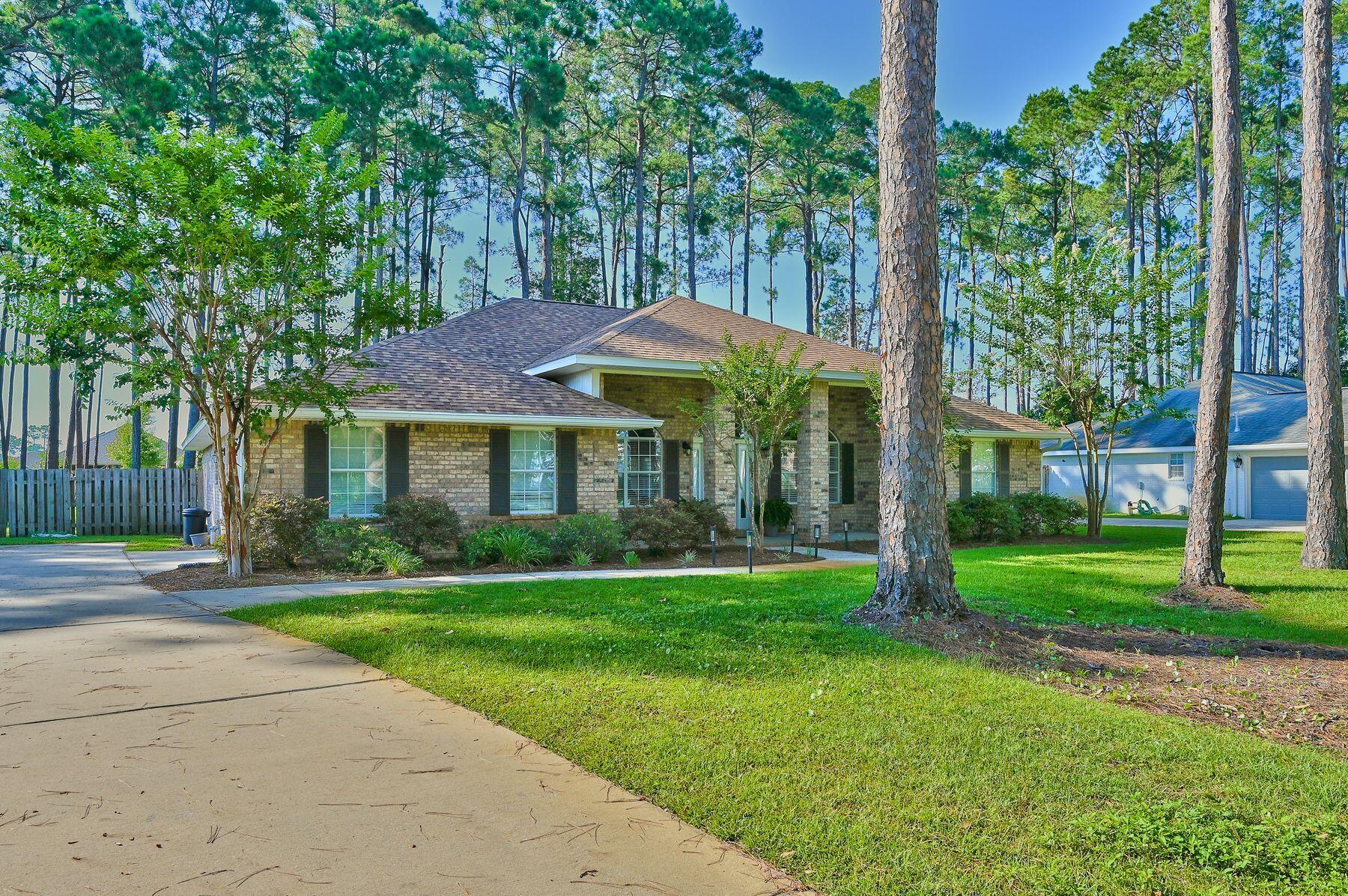 Ideally situated across from Choctawhatchee Bay in the sought-after community of Driftwood Estates, this spacious ranch style home features a new roof installed in June 2022! The oversized lot is more than 1/2-acre with a fully privacy-fenced back yard, allowing plenty of space for pets and kids to play, and even a pool if desired. Inside this gorgeous brick home, the inviting living, dining, and kitchen areas feature hardwood floors and vaulted ceilings. The primary suite boasts a luxurious ensuite bath with a dual sink vanity and a walk-in closet, as well as access to the covered back patio via French doors. Three additional bedrooms, one of which also accesses the patio, allow plenty of space for a large family.