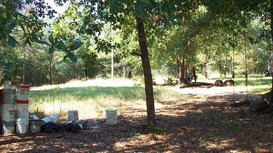 LARGE 6.6 ACRE LOT WITH 2 DWELLINGS IN PLACE. PROPERTY HAS 2 POWER POLES, 1 SEPTIC TANK AND 1 WATER METER.  LOT IS ZONED MUTI-FAMILY AND IS IN FLOOD   ZONE X. SELLER IS GIVING NO VALUE TO THE TWO DWELLINGS.  THE LOT IS SHAPED LIKE A TRIANGLE.