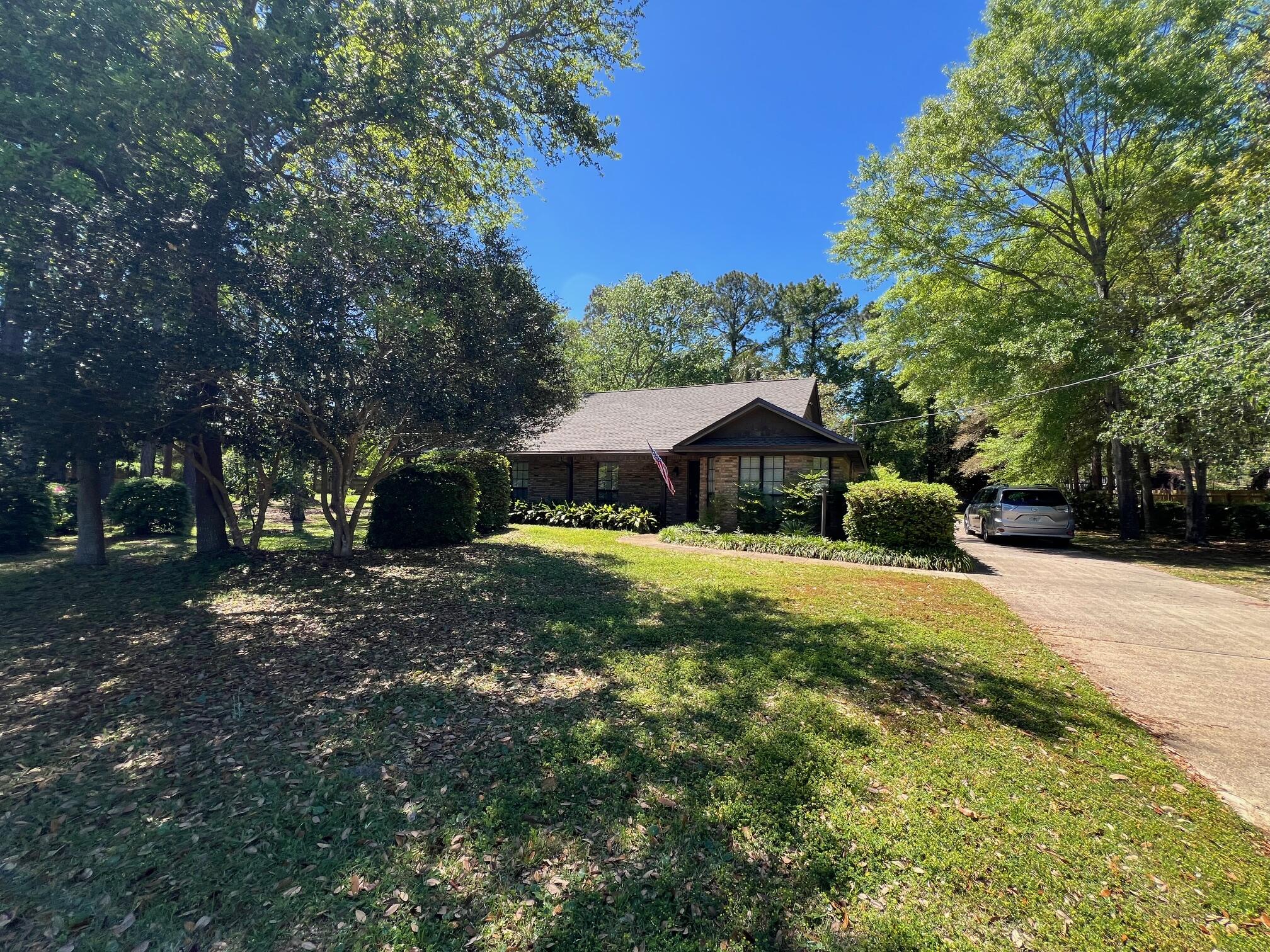 NESTLED ON A VERY PRIVATE LOT THIS ALL BRICK HOME SAYS 'WELCOME HOME'. YOU WOULD NOT BELIEVE THAT THIS LAND AND PRIVACY EXISTS IN TOWN - TRULY SECLUDED IN TOWN COUNTRY LIVING AT ITS FINEST! THE DETACHED GARAGE IS AT THE BACK OF THE HOUSE AND A COVERED BREEZEWAY CONNECTS THE HOUSE/PORCH AND GARAGE. ENJOY YOUR COUNTRY ESTATE AND WIND DOWN FROM THE DAY IN THE SCREENED PORCH OR THE WRAP-AROUND COVERED PORCH. THE ELEGANT FRONT DOOR LEADS INTO THE LIVING ROOM WHICH BOASTS A HIGH CEILING AND GAS BRICK FIREPLACE (WITH BLOWER)SET AT AN ANGLE TO ALLOW GOOD FURNITURE PLACEMENT. FRENCH DOORS OPEN FROM THE LIVING ROOM TO THE PORCH. THE KITCHEN IS OPEN TO THE DINING ROOM - NEW RADIANT TOP STOVE AND NEW FLOORING. THE BAY WINDOW IN THE