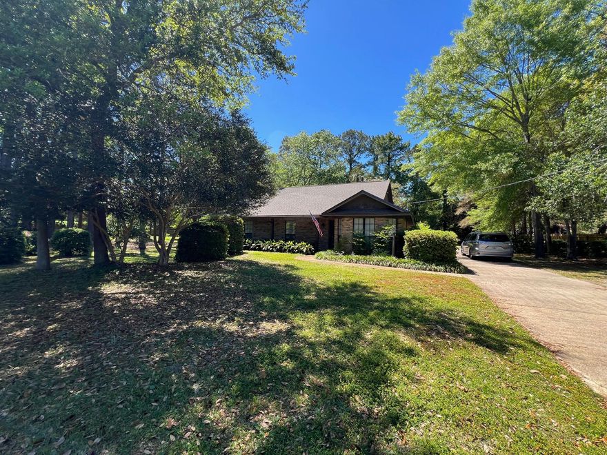 NESTLED ON A VERY PRIVATE LOT THIS ALL BRICK HOME SAYS 'WELCOME HOME'. YOU WOULD NOT BELIEVE THAT THIS LAND AND PRIVACY EXISTS IN TOWN - TRULY SECLUDED IN TOWN COUNTRY LIVING AT ITS FINEST! THE DETACHED GARAGE IS AT THE BACK OF THE HOUSE AND A COVERED BREEZEWAY CONNECTS THE HOUSE/PORCH AND GARAGE. ENJOY YOUR COUNTRY ESTATE AND WIND DOWN FROM THE DAY IN THE SCREENED PORCH OR THE WRAP-AROUND COVERED PORCH. THE ELEGANT FRONT DOOR LEADS INTO THE LIVING ROOM WHICH BOASTS A HIGH CEILING AND GAS BRICK FIREPLACE (WITH BLOWER)SET AT AN ANGLE TO ALLOW GOOD FURNITURE PLACEMENT. FRENCH DOORS OPEN FROM THE LIVING ROOM TO THE PORCH. THE KITCHEN IS OPEN TO THE DINING ROOM  -  NEW RADIANT TOP STOVE AND NEW FLOORING. THE BAY WINDOW IN THE