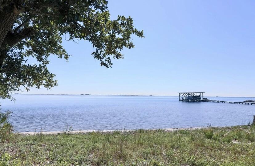 The sellers are open to back up offers. You can own a majestic piece of the Emerald Coast! This lot boasts seventy feet of waterfront property on the sound with over a half an acre. The community boat launch is just one parcel from this lot. Take a drive by and see for yourself how lovely this property and neighborhood is. The sellers have an updated survey and a Biome Jurisdictional Wetland Assessment to share. Build to suit your dream home.