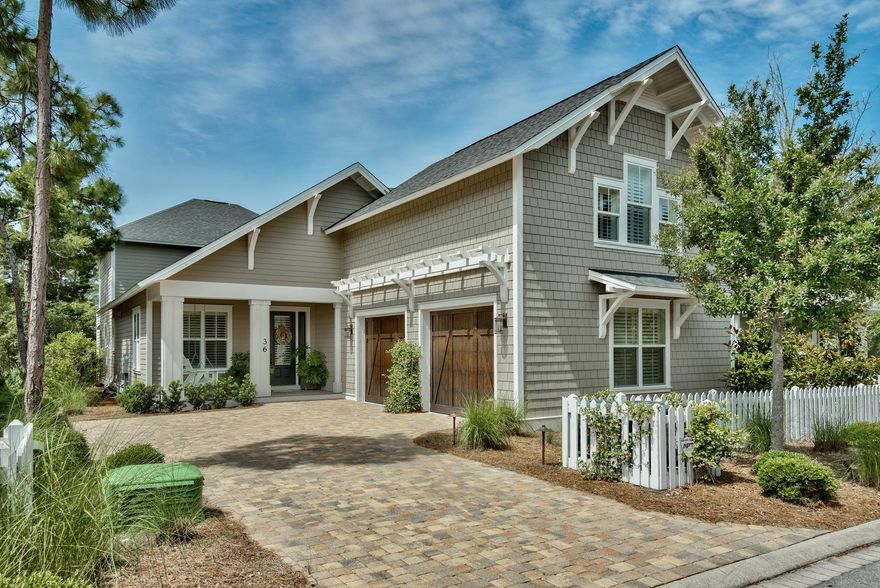 This gorgeous lakefront home is stunning and a must see! Recently redesigned and redecorated with exceptional high end finishes, this property is the perfect beach retreat for friends and family. The kitchen has been totally remodeled with wolf appliances, solid wood cabinetry, oversized custom island, and exquisite counters and backsplash. Adjacent to the kitchen is a beautifully furnished great room featuring a gas fireplace, wet bar with ice maker and wine cooler, and large flat screen TV. The master suite, located on the first floor, boasts two custom closets, coffered ceiling, and a gorgeous bath with custom cabinetry, garden tub, and large walk-in shower. French doors from the great room and master suite lead out to a wonderful screened porch with a coquina shell fireplace, gas grill, and large flat screen TV.  Perfect spot to entertain family and friends!  Upstairs, there are 2 more bedrooms with baths, porch, den with barn style door, office area, and a large finished storage/bonus room.  There is a large carriage over the garage with a king bed, sitting area, bath, kitchenette, built in daybed---perfect for guests!  A lovely dining room, powder bath, laundry room, and 2-car garage complete this special home.  Watersound West Beach is a quiet gated neighborhood that features a community pool, boardwalks, and beach access to one of 30a's most beautiful and secluded beaches.  