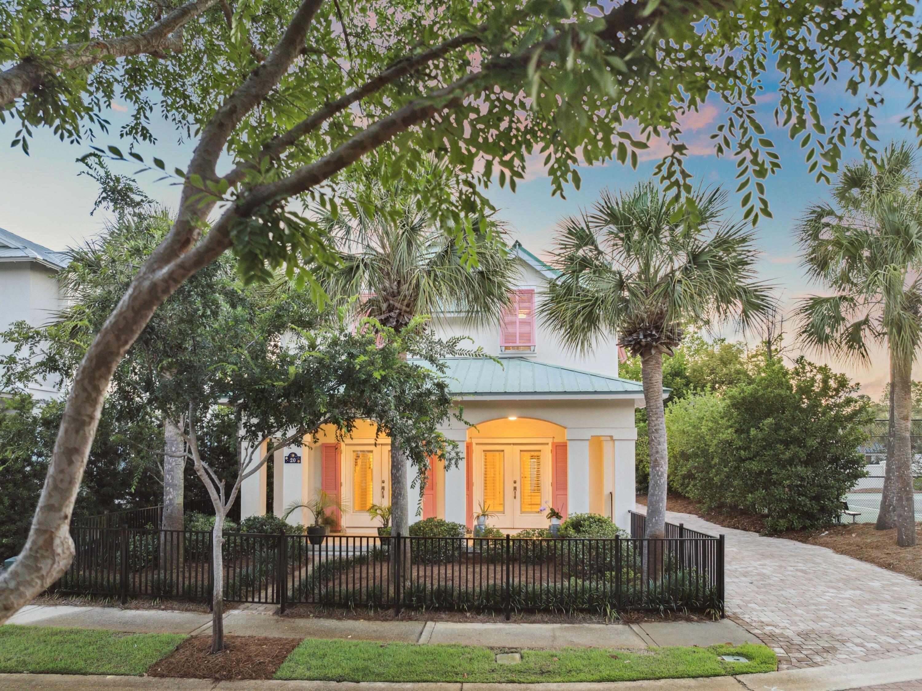 Welcome to this beautifully remodeled coastal retreat, nestled in the highly sought-after Caribe neighborhood, steps from pristine, sugar-white sands. This charming cottage effortlessly combines modern upgrades with timeless island style. As you step inside, you'll be greeted by an open-concept layout that's perfect for entertaining. The brand-new kitchen features stainless steel appliances, sleek quartz countertops, and ample space for meal preparation and socializing. Newly installed flooring and freshly renovated bathrooms bring a touch of modern elegance to every room. The spacious first-floor primary suite offers a private bathroom with a dressing area, a separate shower, and a walk-in closet, providing the ultimate retreat. A convenient half-bath with laundry is also located nearby. Upstairs, two large bedrooms, each with its own private bath, provide ample space for family or guests to unwind in comfort. Outdoor living is just as inviting. Enjoy the serene front porch or relax in the fenced backyard, ideal for pets and outdoor enjoyment. The Bahama-style shutters add coastal character, while the interior plantation shutters allow for natural light to flood the home. For added peace of mind, this property comes with a whole-house generator, ensuring you're always powered up. Located in a secure, gated community with two private beach access points, two pools, and a tennis court, this home offers the perfect balance of relaxation and recreation. And to top it off, the home comes fully equipped with a golf cart for your convenience.