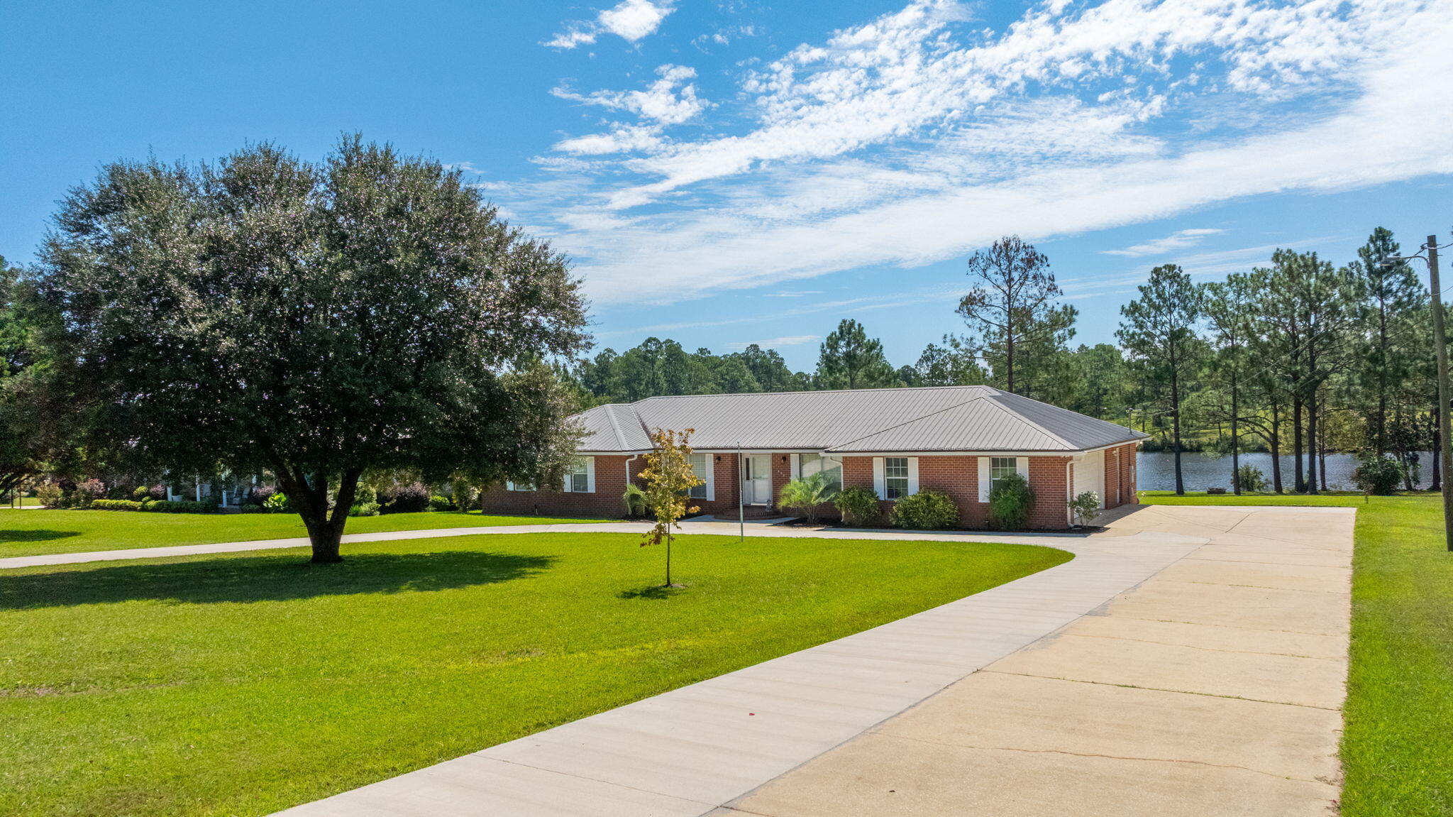 Spacious Waterfront Brick home in Beautiful Ten Lake Estates located just 5 miles North of DeFuniak Springs. Features include 3 bedrooms, 2 baths plus an additional half bath in the garage. lake views from the living room, Breakfast Nook and master bedroom. Home also includes a separate dining room plus a sitting room - perfect for home office or just a quiet area for reading. On the back of the home is a Florida Room with AC and ceiling fan that also faces the lake. The Florida room opens to a 22x19 deck with a grill bump out for those afternoon cookouts!! Seller has redone the dock with railings and a swimmer's gate. The 2 car garage includes a workshop area plus a Great Area for Darts!!! A half bath is also in the garage. Circular Drive offers additional parking.