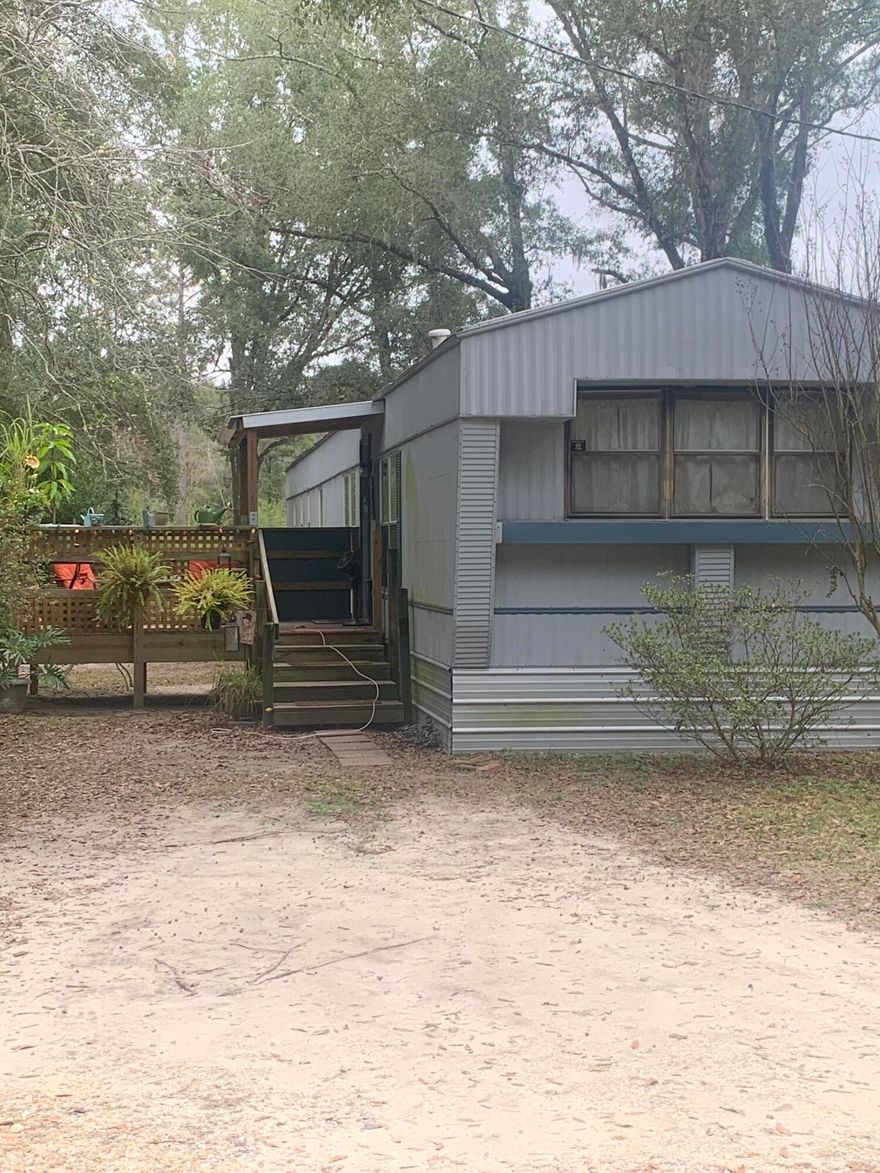 Great investment opportunity.  Zoned Residential/Commercial with lots of possibilities.  The parcel by the road is two lots that has the mobile home with all utilities and the parcel behind it is another two lots that are included in the listing price.  The home is currently tenant occupied paying $800 monthly on a month to month basis.    Do not walk the property without permission from listing agent.  Buyer should verify all information to their satisfaction.