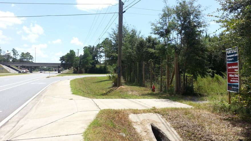 LOOKING FOR A DEAL ON MEGA RETAIL VISIBILITY AND SUPER EASY ACCESS TO I-10?! 14+/- ACRES AVAILABLE NOW FOR IMMEDIATE DEVELOPMENT! AWESOME LOCATION AT THE NORTHWEST CORNER OF THE INTERCHANGE AT I-10 AN HWY 87 WITH 22,000 AADT ON I-10 AT HWY 87 INTERCHANCE, (PER FDOT 2013 TRAFFIC COUNTS). TAKE ADVANTAGE OF THE FLORIDA PANHANDLE'S PRIMARY HIGHWAY TRANSPORTATION CORRIDOR AND SUPPLY ROUTE TO THE NEW AIRBUS FACILITY IN MOBILE! THE SOUTH SIDE, BOUNDED BY I-10, IS APPROX. 1,192 FT. THE NORTH SIDE IS BOUNDED BY A LARGE GAS STATION WITH BIG-RIG PARKING, WAFFLE HUSE AND HOLIDAY INN TO THE NORTH AND IS APPROX. 169 FT. A UTILITY EASEMENT TRANSECTS THE REAR OF THE PROPERTY. THE EXISTING HOUSE IS ABANDONED AND HAS NO VALUE. CURRENT ZONING IS AGRICULTURAL. COMMERCIAL REZONING LIKELY BASED ON LOCATION AND