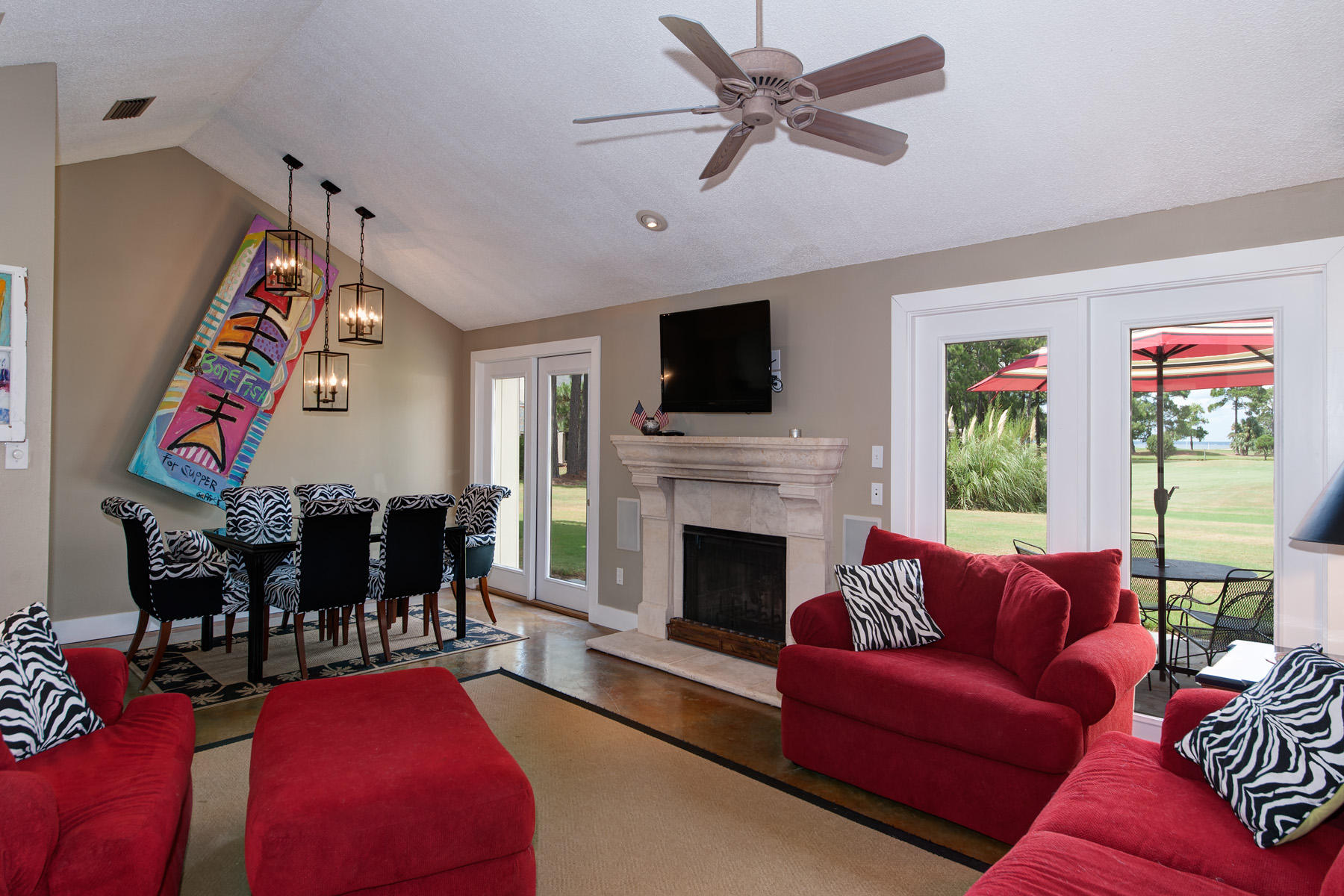 Enjoy views of The Links Golf Course through every French door and window along the rear of this beautifully maintained home, comfortably contained all on one level at Sandestin Golf and Beach Resort. Its open living and dining areas share a cathedral ceiling and chic, stained concrete floor. French doors flanking a fireplace with impressive stone mantle illuminate the space with natural light throughout the day. The kitchen has been updated with stainless steel appliances and features French doors to a sheltered grilling patio. Custom plantation shutters in the master bedroom can be opened to reveal the serene view, or closed to create an equally serene, private retreat. The Links Golf Course is one of four championship courses found at Sandestin, which join other popular attractions.