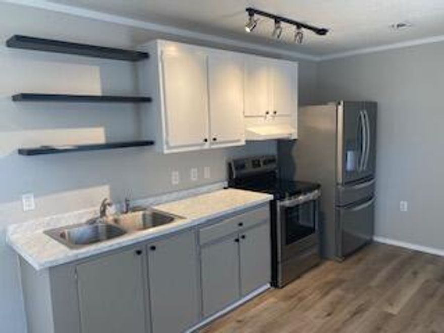 Fully renovated manufactured home ready for new owners!  Outside, you will see that the yard has recently had new chain link fencing added.  Also, both doors have a deck, perfect for grilling or entertaining.  You will notice the open concept as you enter.  All new lighting and ceiling fans brighten the rooms, which boast new Cali Bamboo LVP throughout the home.  The kitchen features beautiful cabinets with new countertops and open shelving for storage.  Also, check out the new stainless steel stove and refrigerator.   The split bedroom plan has one bedroom in the front of the home and one in the rear.  The renovated bathroom also features a bard door for that country feel.  Septic tank is around 2 years old.  Schedule your appointment today!