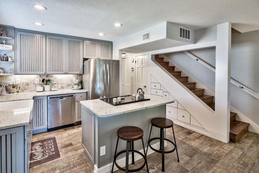 Call and set your appointment with this 3 bedroom knockout while you can! This is one of the nicest units in all of Seascape. Some of the numerous updates that differentiate this from the rest include: a reconfigured first floor layout, new interior paint throughout, complete kitchen renovation featuring all new cabinets with under-mount lighting, farm sink, complete stainless steel Whirlpool appliance package, granite counter tops, and recessed lighting. The stairwell was also remodeled with cutouts for additional lighting, custom drawers for storage by the kitchen, AquaPower Tankless Water installed, Front Window Plantation Shutters, Wood Look Tile throughout the first floor, all new ceiling fans/light fixtures, and much more! A few other nice features are the carport with...