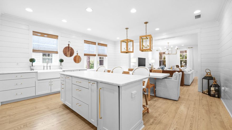 Nestled in the picturesque, highly sought-after Winter Garden phase of Watersound Origins, this exquisite 4-bedroom, 3.5-bath Huff built home has undergone a complete, top-to-bottom renovation -- offering a rare combination of refined style, thoughtful functionality and unmatched natural surroundings. From the whitewashed floors to the custom shades, inside, no detail has been overlooked. The chef's kitchen is a true centrepiece, featuring a large island with Dolomite countertops--perfect for everyday living and entertaining. Premium appliances include a custom built-in coffee bar by Miele, gas range and dishwasher, Fisher & Paykel refrigerator, under-counter ice maker, custom cabinet panels, marble backsplash, and white oak cafe shelving--creating a timeless yet modern aesthetic. Every finish and fixture has been selected for both beauty and durability, creating a home that balances modern sophistication with warmth, making each space elevated yet livable. Flowing seamlessly from the kitchen, the family room is bathed in natural light and accented by Serena & Lily designer lighting, creating a bright and inviting space for gatherings, quiet mornings, or cozy evenings at home. The open layout fosters effortless connection between cooking, entertaining, and everyday living, while maintaining a sense of warmth and intimacy. The flexible floor plan is uniquely versatile--equally perfect for a growing family or a couple looking to downsize without sacrificing space. The main level features a private primary suite and guest suite, each with ensuite baths. Upstairs offers two generously sized bedrooms--one with built-in bunks and the other designed for guests with two queen trundle beds--along with a fully renovated bath showcasing a vintage cast iron double sink and custom lighting. The thoughtful separation of living spaces creates an ideal layout, giving children and visitors their own level while preserving privacy and tranquility in the main living areas. With its adaptable design and endless possibilities, this home effortlessly suits every stage of life. Designed with everyday living in mind, the home includes exceptional organizational solutions throughout. Custom storage by California Closets enhances the entry hallway, laundry room, and all bedrooms, including a thoughtfully designed school drop zone. Built-in laundry cabinetry adds both efficiency and style, reinforcing the home's emphasis on function without compromise. Unlike newer phases, Winter Garden is distinguished by its mature, established trees, creating a sense of privacy, shade, and timeless coastal charm that is increasingly hard to find. Whether you're hosting friends, enjoying a quiet morning coffee, or simply soaking in the year-round sunshine, the screened in patio and expansive yard offer the perfect backdrop for serene, peaceful and private outdoor living. The neighbourhood park and green space out your back offer a safe and inviting setting for children to play, further enhancing the home's family-friendly appeal. Every corner of the property highlights the natural beauty and charm of this stunning community. Combined with access to Watersound Origins' premier community amenities, including a golf course, fitness centre, tennis and pickleball courts, swimming pool, walking trails and a dock on Lake Powell, this extensively renovated, turnkey home offers an exceptional opportunity for elevated coastal living in one of the area's most desirable neighbourhoods.