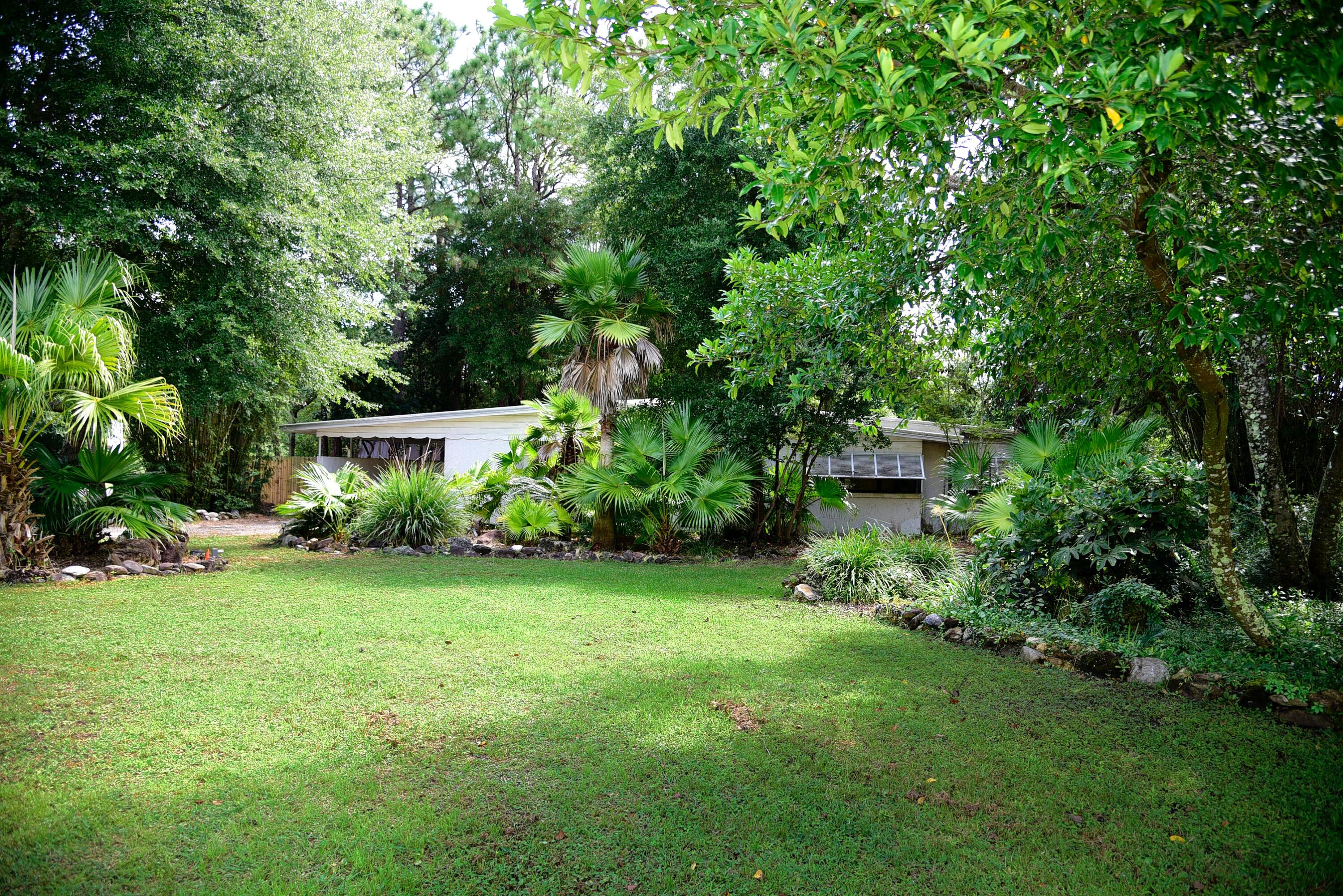 Charming Florida cottage tucked away in lush, landscaped Fully renovated 3 bedroom, 2 bath home on a large corner lot in a quiet neighborhood! Many upgrades include stainless steel appliances, white shaker cabinets, granite & vinyl plank flooring in the kitchen, dining and living areas. Updated guest bathroom down the hall with 2 guest bedrooms. Further down the hall is the master suite with very large walk in closet and private bathroom. Great views from all windows. Large screened in porch overlooking the huge backyard which boasts a fire pit and elevated gardens. Owner will consider pets with certain restrictions. Any pet must be spayed/neutered, housebroken, and current on all shots. Non refundable pet fee is required. NO Smoking. Any person 18 years old or older must complete separate
