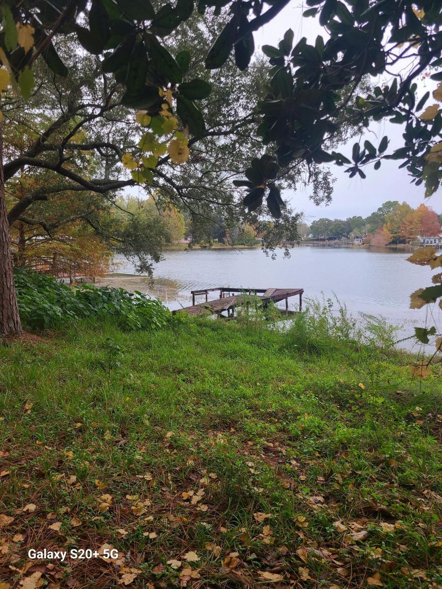 Discover the untapped potential of 77 Widner Cir in Defuniak Springs, Florida. This expansive .29-acre property, with utilities readily available for hookup, offers a canvas for your dream home with breathtaking waterfront views of the renowned Lake Juniper. The value of this parcel is evident in its prime location, providing an opportunity to own a piece of the growing community of Defuniak Springs. While a mobile home on the property holds no significant value and the dock requires attention, the true allure lies in the chance to create a custom residence tailored to your vision. Imagine waking up to the sun's first light reflecting off the tranquil waters and enjoying direct access to the lake from your private dock. Take a drive around the lake to understand why  this area is in demand. With proximity to local amenities, schools, and recreational facilities, this property is not just an investment; it's an invitation to embrace the charm of lakefront living in Defuniak Springs. Contact us today to explore the possibilities that await at 77 Widner Cir.