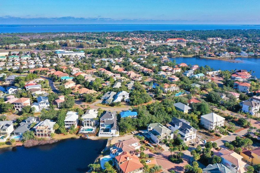 Enjoy the best of both worlds in this coastal contemporary beach retreat that is both lakefront in the gated community of Destiny and primely positioned just two tiers off the Gulf of Mexico. Remodeled in 2018 by Coastline Luxury Homes, this five-bedroom plus bunkroom, four-bath home features a large open floor plan with a wall of floor-to-ceiling windows that provide an abundance of natural light and a frame for lake views and evening sunsets. A designer kitchen features professional-grade appliances, custom Shaker cabinetry, quartz countertops, large island and wine cooler. A first-floor master suite occupies its own private wing of the home and features pool and lake views and spa-like bathroom amenities. Customer designer lighting and window treatments, timeless furnishings, a security