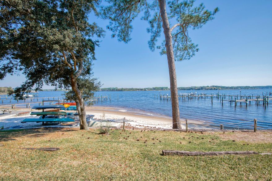 Beautiful Waterfront Townhown with Boat slip and community pool. Three bedrooms, two and half baths. First floor is tiled and has updated kitchen with stainless appliances. Sliding glass doors open to screen porch overlooking the bay. Master bedroom has french doors that open to a balcony with stunning evening views of the water. This community is close to golfing, swimming, fishing, & shopping. Bring your boat!