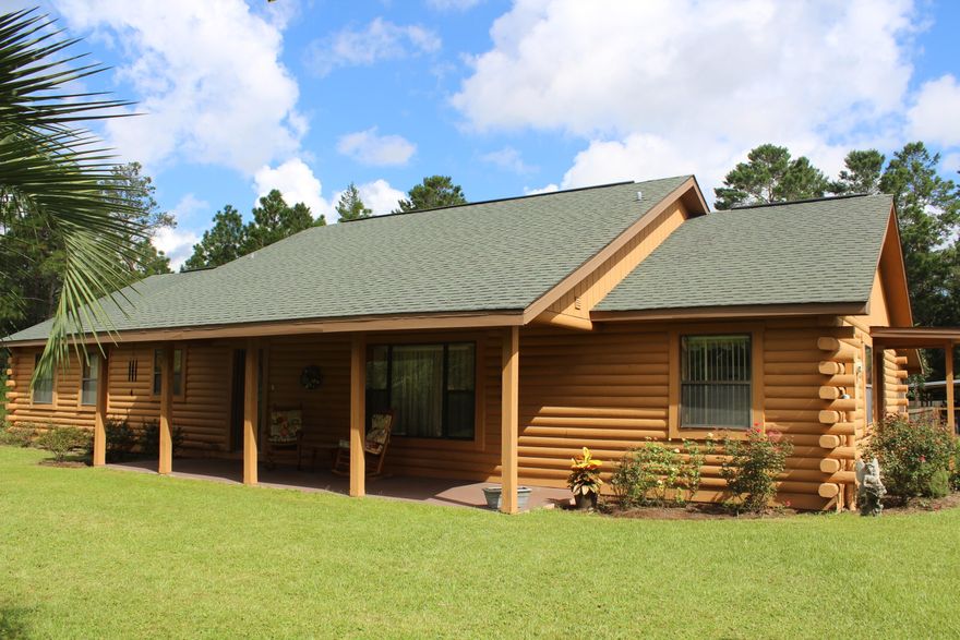 Get ready to call this place HOME! Beautiful Log Cabin on 1.39 acres located conveniently to Crestview & DeFuniak Springs. You don't see custom built homes like this. The covered front porch is made with rocking chairs in mind. The open floor plan makes living here easy! The living room features a 12 ft cathedral ceiling. Living room, dining room, kitchen, laundry, foyer & baths all have ceramic tile floors. Kitchen has Birch cabinets & features an attached dining area. Outside living space has a screened in back porch & fenced area perfect for pets. Detached 2 car garage has a half bath & a separate area for storage. The landscaping includes Crepe Myrtles, Magnolia tree, Roses & many more plants that have been lovingly cared for! Seller to provide AHS Home Warranty with acceptable offer.