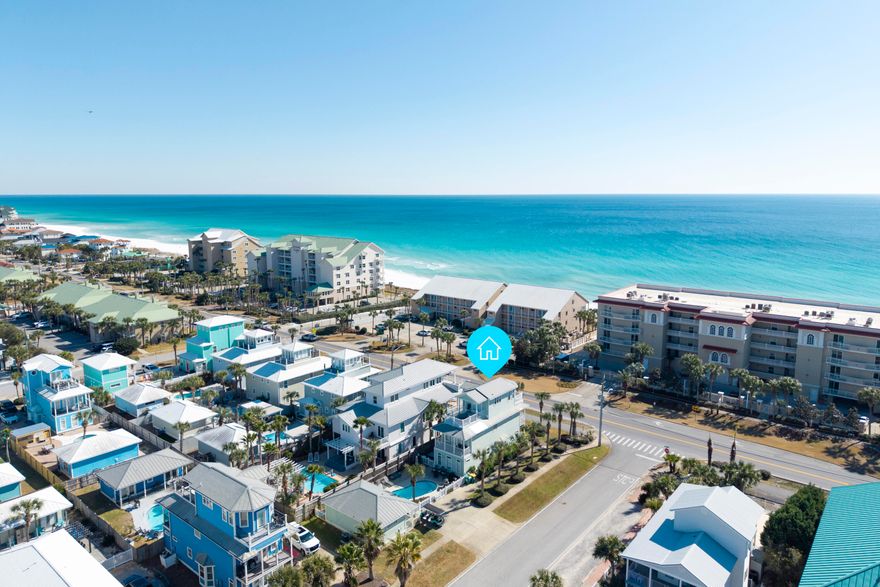 Located directly along Scenic Hwy 98 on a prominent corner lot, this exceptional three-story coastal retreat offers Gulf views from the second & third levels and is just 0.1 miles from the Shirah Beach Access, a leisurely 2-minute stroll to the sugar-white sands. Thoughtfully designed & impeccably maintained, the property presents a rare ''two-homes-in-one'' configuration ideal for personal enjoyment & high-performing short-term rental use. The 4-bedroom main residence is complemented by a separate 2-bedroom carriage house, with a heated pool & pool deck serving as the private focal point between the two structures. This flexible layout provides privacy & versatility well-suited for hosting guests, multi-generational living, or maximizing rental potential. The carriage house also features a kitchenette, a full bathroom, and a walk-in closet, offering comfortable & independent accommodations. The home is tastefully decorated & offered turnkey, featuring solid surface flooring throughout, multiple living areas, and balconies positioned to capture Gulf breezes & views. A golf cart is included, enhancing convenience for beach access & easy enjoyment of the surrounding coastal community.

From an investment perspective, the property demonstrates outstanding performance, generating $225.1K in rental income in 2024, $235.4K in 2025, and already securing $129.2K in confirmed bookings for 2026. With its prime Scenic 98 location, Gulf views, flexible accommodations, and proven income history, this offering represents a compelling opportunity in one of Destin's most sought-after beach communities.