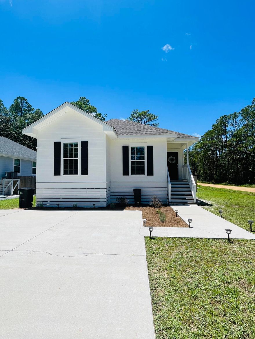 Welcome to this quaint Santa Rosa Beach cottage. This home features 3 bedrooms and 2 bathrooms on a large corner lot. As you enter this darling cottage you are greeted by a spacious open concept room with living, kitchen and dining. This is a great space for entertaining and having family functions. There is a large wall to hold a large TV for sports and movie night. The kitchen has a wrap around bar where people can sit and visit while cooking or have a delicious breakfast. In the kitchen, there is plenty of counter space and large pantry. The dining room area has ample room for family gatherings or working a puzzle. This home has a laundry room just off of the kitchen area but is conveniently located near the backyard area to drop clothes or towels.