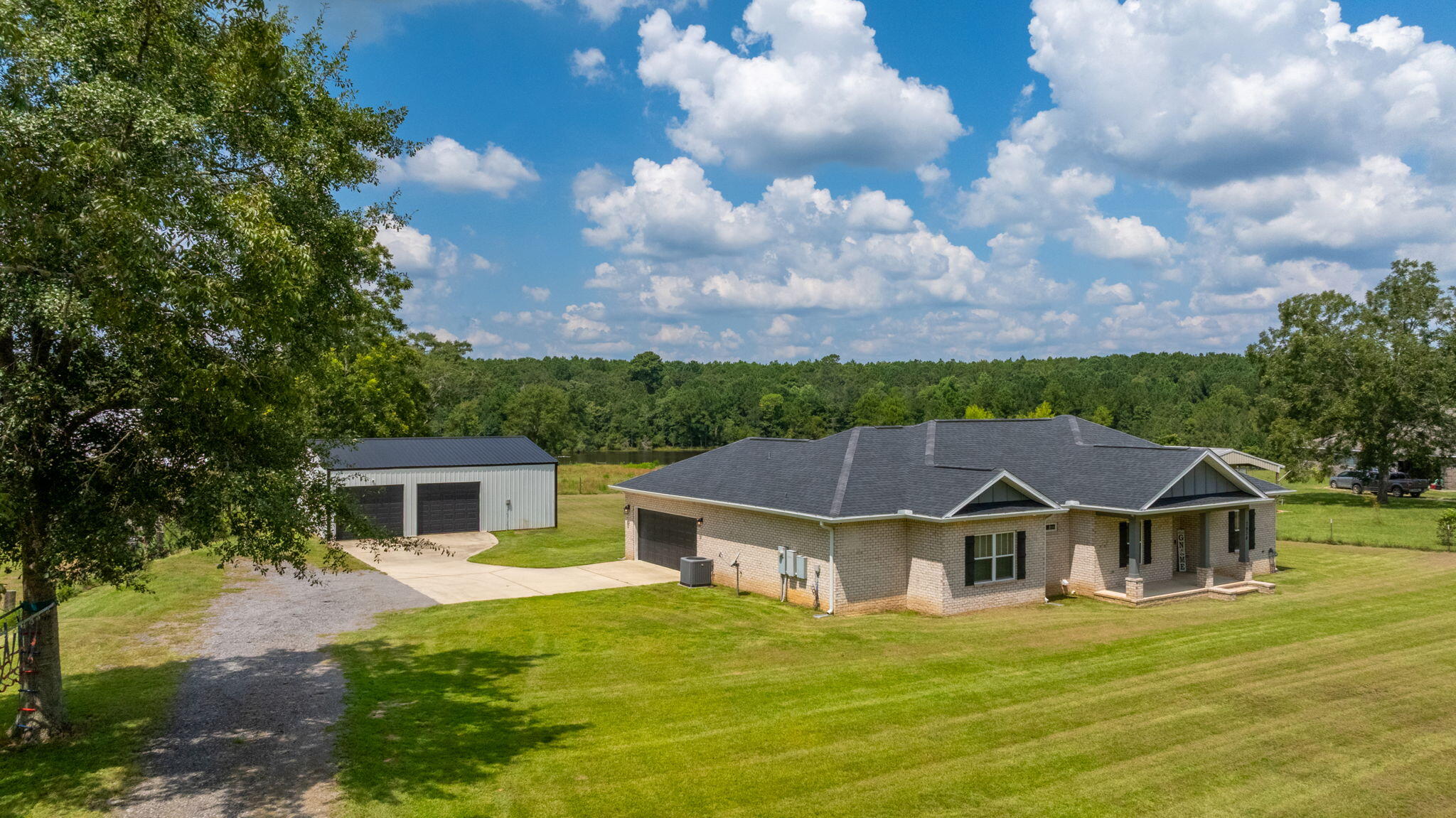Welcome to this beautiful brick home perfectly situated on an acre with serene views overlooking a neighboring pasture and pond. Step inside to find a spacious open floor plan with soaring cathedral ceilings, luxury vinyl plank flooring throughout, and a thoughtful split-bedroom layout featuring a stunning master suite with a dedicated home office.The private master suite offers a peaceful retreat, while the large living and dining areas provide plenty of room for gatherings. Out back, you'll love the incredible 3036 metal workshop with dual automatic access doors--ideal for hobbies, storage, or projects of any size. A portion of the shop is a fully enclosed 1230 heated and cooled bonus space, perfect for the ultimate hangout spot, home gym, or the beginnings of an awesome in-law suite.