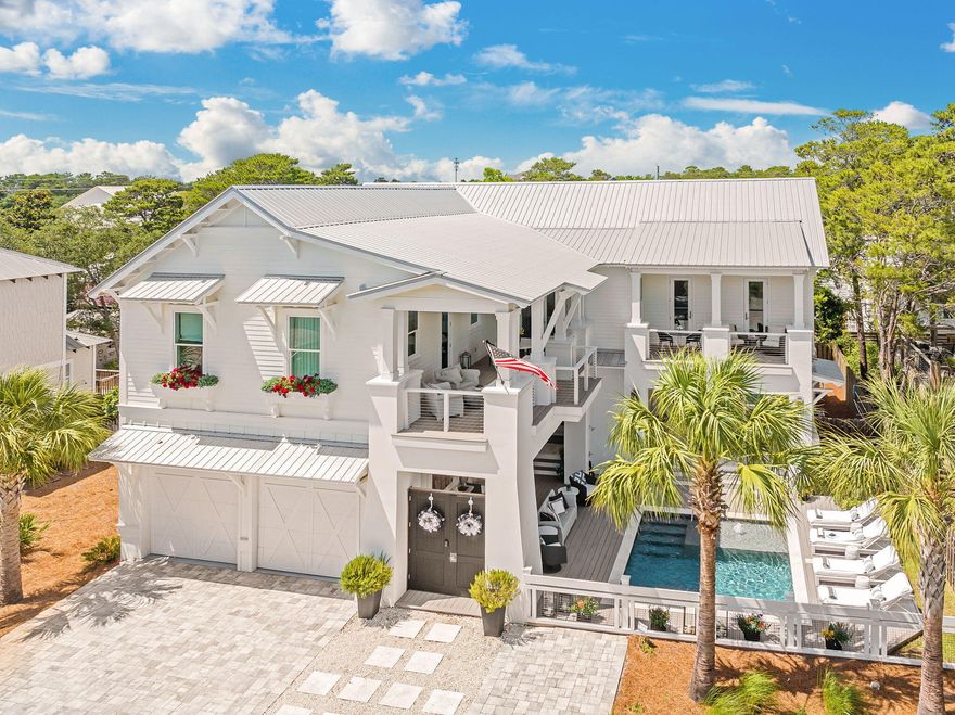 OPEN HOUSE THIS THURSDAY 2/12 FROM 11AM TO 3PM AND FRIDAY 2/13 FROM 11AM TO 3PM. Where refined coastal architecture meets the most coveted stretch of 30A.Nestled in the heart of Gulf View Heights along Scenic Highway 30A, this exceptional coastal estate redefines luxury beachside living. Just a five-minute stroll to the sugar-white sands of Gulf View Heights Beach Access, this six-bedroom, six-bathroom residence spans over 4,060 square feet of impeccably designed living space, seamlessly blending timeless architecture with modern indulgence. Upon entry, the grand living room captivates with 22-foot coffered ceilings, creating a dramatic sense of volume and sophistication. The chef's kitchen serves as the heart of the home, featuring a massive quartz island, commercial-grade KitchenAid appliances, a six-burner gas range, built-in refrigerator, ice maker, and a striking statement range hoodperfectly suited for both elevated entertaining and everyday luxury. Coffered ceilings continue throughout, while the formal dining room is enhanced by a custom wet bar with wine chiller, ideal for evening gatherings.

Expansive French patio sliders open to a private courtyard oasis, where indoor and outdoor living blend effortlessly. The fully equipped summer kitchen boasts a built-in Coyote grill, refrigerator, warming drawer, and quartz countertops, all set atop elegant travertine tile. The courtyard flows seamlessly to the resort-style pool deck, complete with composite decking, travertine coping, and ample lounging space for soaking up the Florida sun.

The main level also offers a versatile bedroom currently utilized as a home gym, a full bath, and a stylish half-bath for guests. Upstairs, a spacious loft anchors the second level, accompanied by two guest bedroomsincluding one transformed into a custom-designed closetconnected by a Jack & Jill bath. A private home theater suite features its own spa-inspired bathroom with soaking tub, walk-in shower, and dual vanities.

The primary suite is a true sanctuary, offering a private balcony, expansive walk-in closet, and a luxurious en-suite bath with soaking tub, oversized shower, and refined finishes. A second wet bar off the loft enhances evening convenience, while the oversized laundry room provides abundant cabinetry, counter space, and a utility sink. One of the upper balconies overlooks the pool, extending the home's elevated outdoor living.

Additional highlights include a Generac whole-home generator, infrared outdoor heaters, custom wallpaper and draperies, and all-new designer lighting throughout. The grounds are further enriched by mature fruit trees, including orange, lime, lemon, and grapefruit.
Ideally positioned moments from world-class dining, boutique shopping, and the iconic beach towns that define 30A, this remarkable residence offers a rare blend of privacy, luxury, and walkable beach access. Scenic Highway 30Awhere crystal-clear waters, charming coastal communities, and timeless elegance converge.
Experience coastal living without compromise.
Welcome to your legacy home on 30A.
