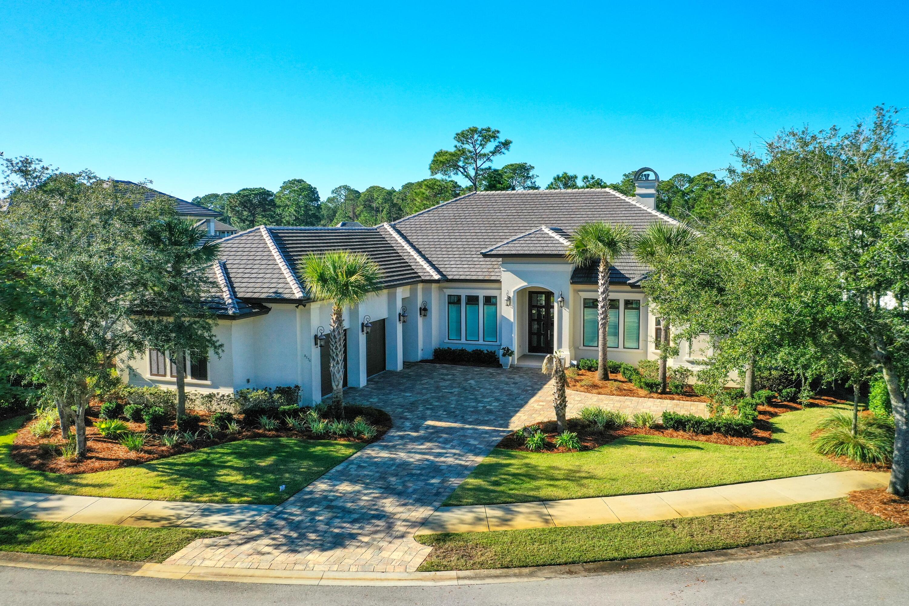 This beautiful single level home shows like new and enjoys lake and golf course views. Enter through the double glass doors into the open plan living area featuring vaulted ceilings, built-in cabinetry, crown molding, fireplace, hard wood flooring, and a wall of large windows providing an abundance of natural light. The gourmet kitchen offers an oversized island, quartz counter tops, and Dacor stainless steel appliances including a 6 burner gas stove and full size wine refrigerator. Off the kitchen is a walk through pantry area leading to the screened summer kitchen with sink, mini fridge, and gas grill with range hood. The home features a separate formal living room and office.
