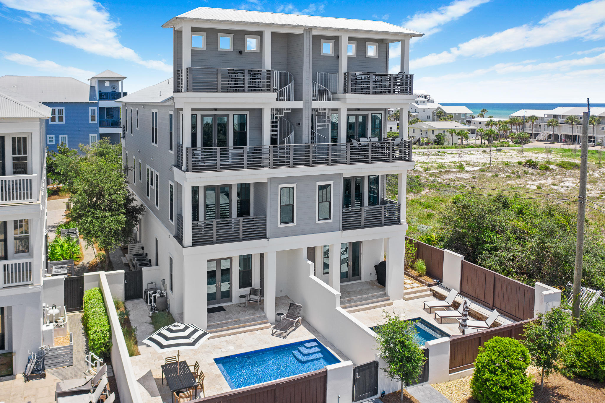 SEE VIDEO! Exemplary coastal design offers expansive gulf views; steps from beach access. Main residence consists of 4 bedrooms en suite; plus additional separate living quarters complete w/full bath & kitchenette. Bonus room opens to a private courtyard retreat w/heated pool enclosed w/privacy fence perfect for outdoor entertaining. First floor features an oversized garage, separate living area along with elevator access. Second floor comes w/two master suites complete with private balcony & gulf views to include an additional bunk room en suite. Main living along w/additional Master en suite w/private balcony is found on the third floor along w/additional balcony & observation tower leading to a fourth level where sunset views may be enjoyed.IMMACULATE NEVER RENTED W/170K PROJ. INCOME