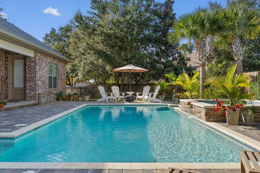 WELCOME HOME to Florida living at its best. This gorgeous custom built 4 bed 3 bath POOL home is conveniently nestled in Camellias, a sought after gated community on the intercostal water with deeded access to the Santa Rosa Sound. Just minutes to the local stores and the breathtaking white sandy beaches of the Gulf of Mexico.Your 3025 sq. ft. home is only 2 years young with all those wish list extras already taken care of for you. Private Gunite pool with spill over spa ~paver pool deck & undercover porch to cook out and enjoy those wonderful Florida evenings all enhancing your little piece of paradise.This custom-built home greets you with a courtyard entrance & sweeping arch porch which opens to the  grand foyer ~home is fully tiled in all wet areas and LVP in the main living areas & bedrooms ~ high ceilings, decorative trays and the coastal color palette radiates a light and bright feeling throughout . Open flow into the formal great room overlooked by the Spacious gourmet kitchen featuring custom cabinets ~ granite countertops, tiled backsplash, center island, pantry, stainless steel appliances offer a slide in vented gas range and additional cabinet housing with your built in microwave and 2nd oven for those days of entertaining. Smooth top bar & large breakfast nook with access to the back porch offers lots of dining choices. This open floor plan boasts plenty of space providing the perfect family setting. Master bedroom/bathroom suite has a separating entrance area accommodating his and her closets. Master bed overlooks the pool and has access to the back porch while the luxurious master bath offers a his and her vanity area, long soaking tub and separate corner tiled walk-in shower with dual shower heads.Master bath has access to the large laundry room with lots of additional hanging space, cabinets and under-mount sink. This split floor plan home has oversized additional bedrooms with the 4th bedroom enjoying its own bathroom with step in shower and access to the covered porch and pool. Perfect for a teen suite of guest room. Large additional room off the main foyer has double pocket doors and could be utilized as a home office, gym room or den. You will appreciate the attention to detail throughout this custom-built home enhanced by many additional features .... gas tankless water ~ gutters ~ shadow box privacy fencing and professional landscaping ....... to name a few... Relocating to Hurlburt Field ..no problem you are within a 20 minutes' drive from the front gates and still conveniently nestled between Pensacola and Destin with easy access to both local airports and a straight drive up Hwy 87 to the I-10 .Call today to schedule your private showing .

