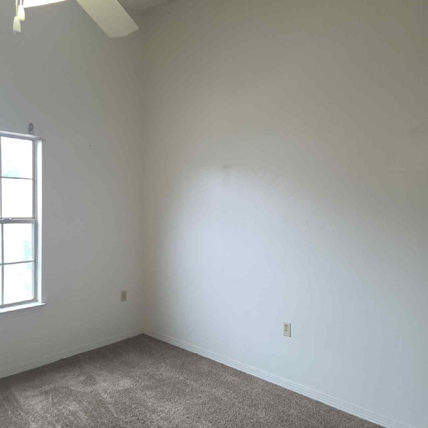 Second-level 1 bedroom, 1 bathroom apartment featuring a bright and welcoming layout. The kitchen includes ample cabinetry and a convenient pantry for extra storage. Large windows throughout the unit provide excellent natural light, creating an open and airy atmosphere. A comfortable and well-designed space in a great location, ready for move-in.