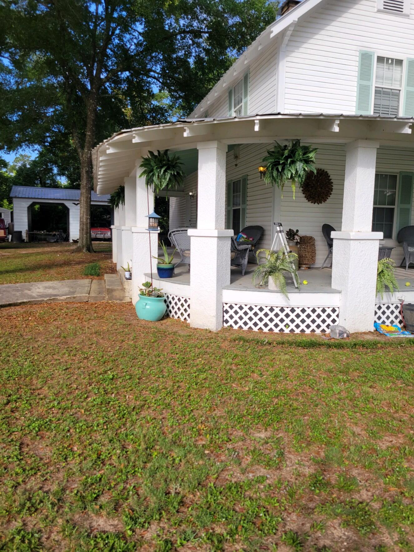 Historic home with wrap-around porch, just 1 block from beautiful Lake DeFuniak! FIVE bedrooms, 2.5 baths! Completely updated! Hardwood floors in main living areas. There are 3 very charming original fireplaces left intact (non-functioning). One fireplace is located in the downstairs master bedroom with another in the master bathroom! Master bath has large claw foot tub and separate shower. The large utility room doubles as a half bath as well, conveniently located by the kitchen and back door, leading out to the new deck and large back yard. Upstairs are 4 additional generously sized bedrooms and 1 full bath. Carport is located in the backyard next to a large storage shed.