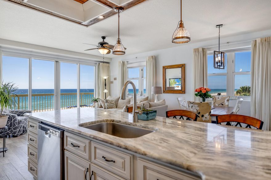 Decked to the nines, this corner unit leaves no stone unturned. First, it is a corner unit with wrap around balcony and amazing views from its 294 sq ft balcony. This unit is customized and upgraded to the max from the continuity of porcelain plank tile throughout to consistent Calcutta Plata LG Viatera Quartz countertops in the kitchen and all baths. The kitchen has been opened up and all new, high quality cabinets have been installed with soft touch drawers. A black quartz drop-in, deep kitchen sink with a Delta touch sensitive, brushed nickel faucet has also been installed.